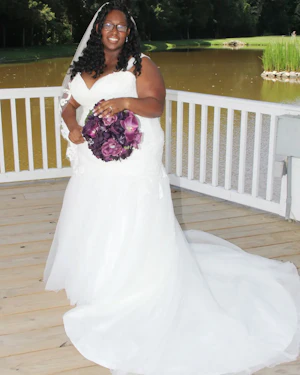 Bride Wearing Plus Size Mermaid Wedding Dress Called Georgia By Rebecca Ingram And A Purple Bouquet