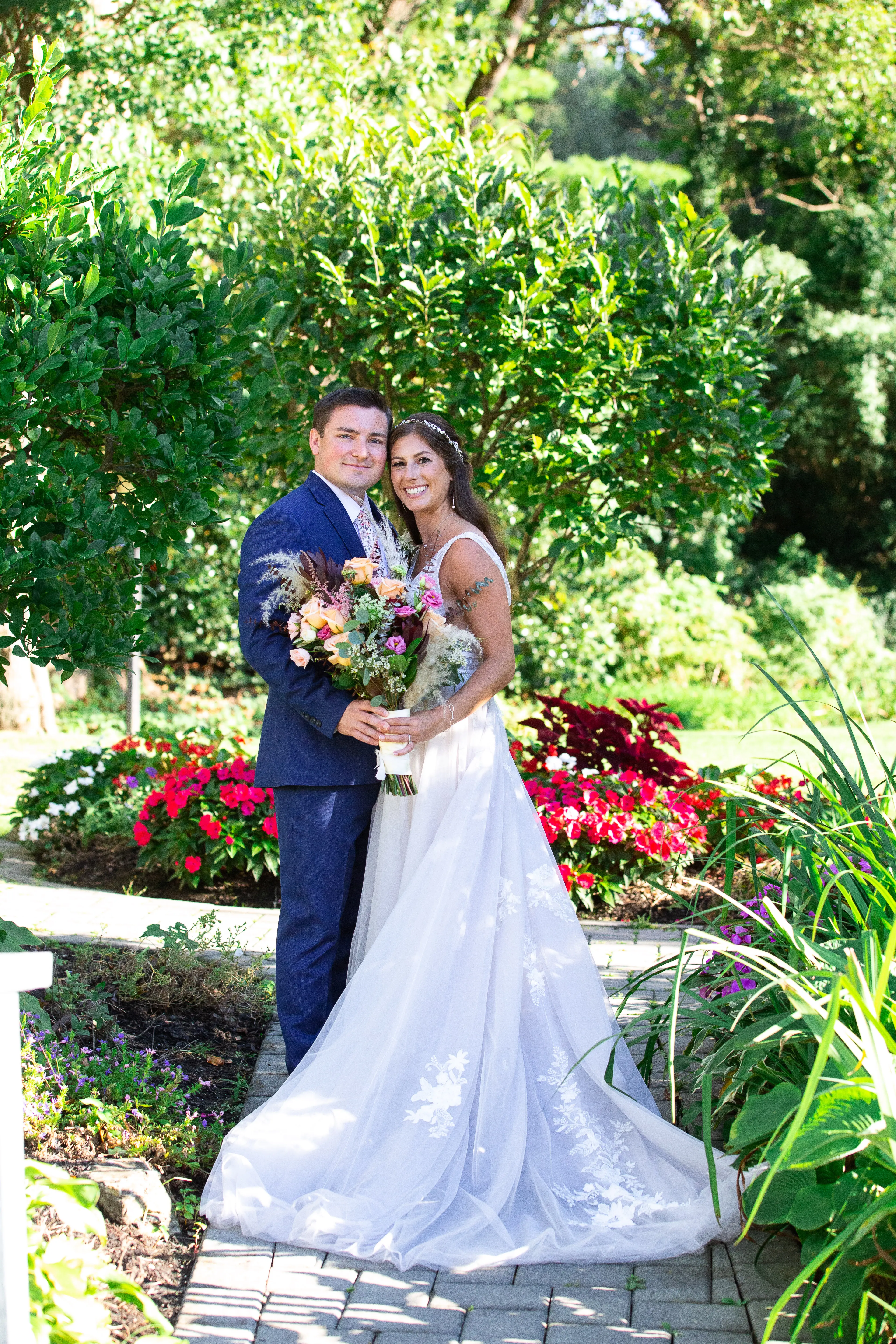 Bride wearing Lace A-line Wedding Dress called Raelynn by Rebecca Ingram and her groom