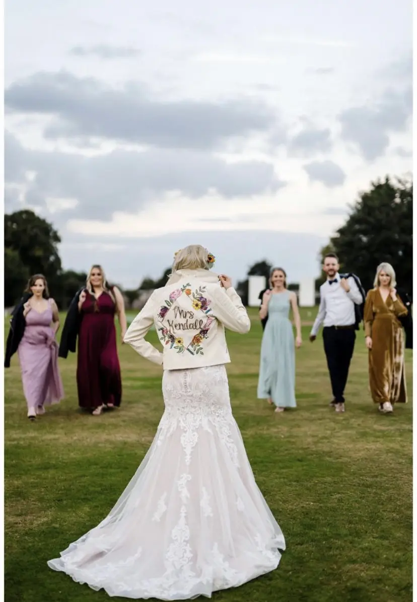 Bride with Wedding Party with Customized Bridal Jacket Wearing Elegant Fit-and-Flare Bridal Dress by Maggie Sottero