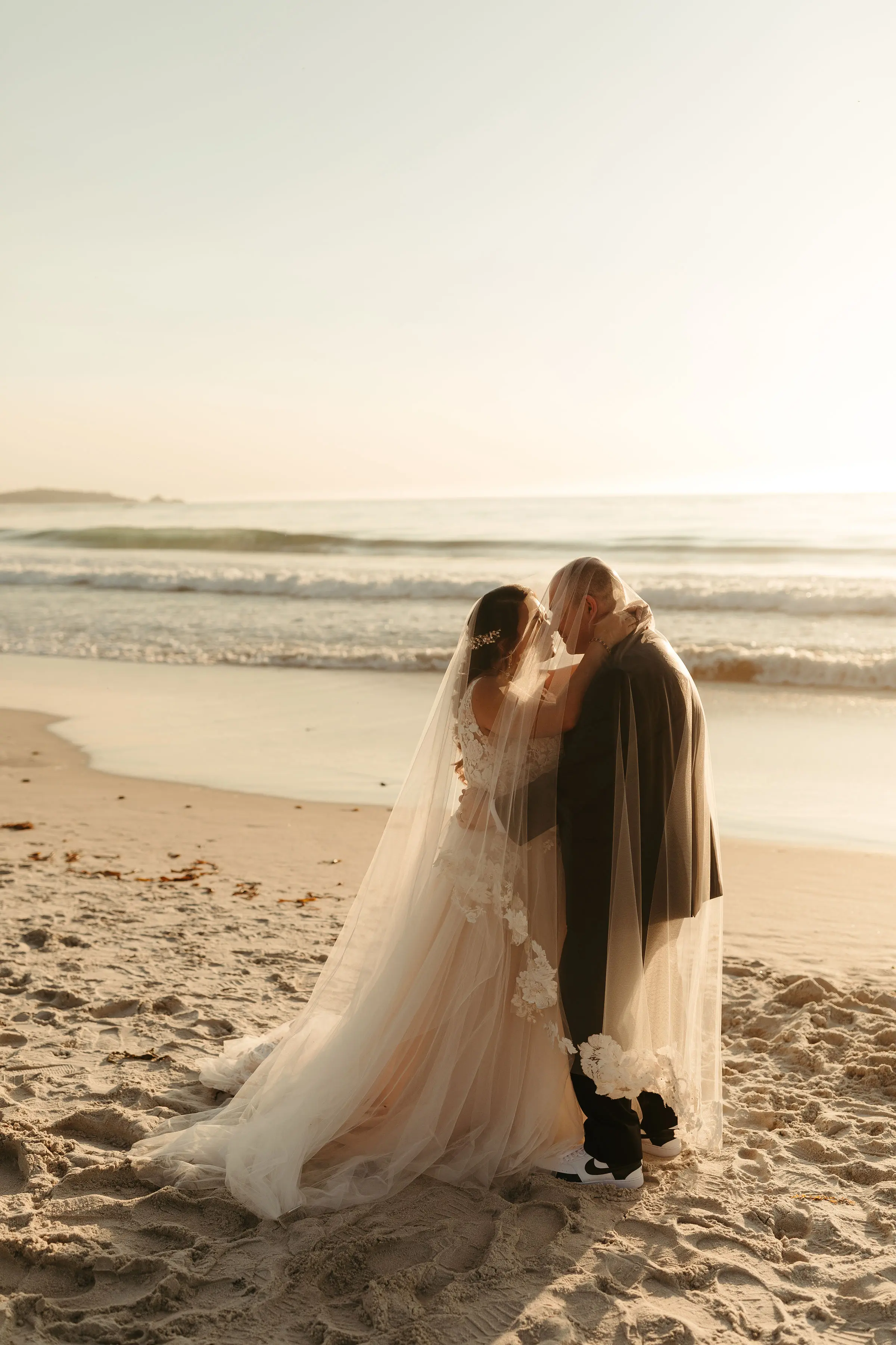 Bride with groom wearing affordable A-Line floral motif wedding dress.