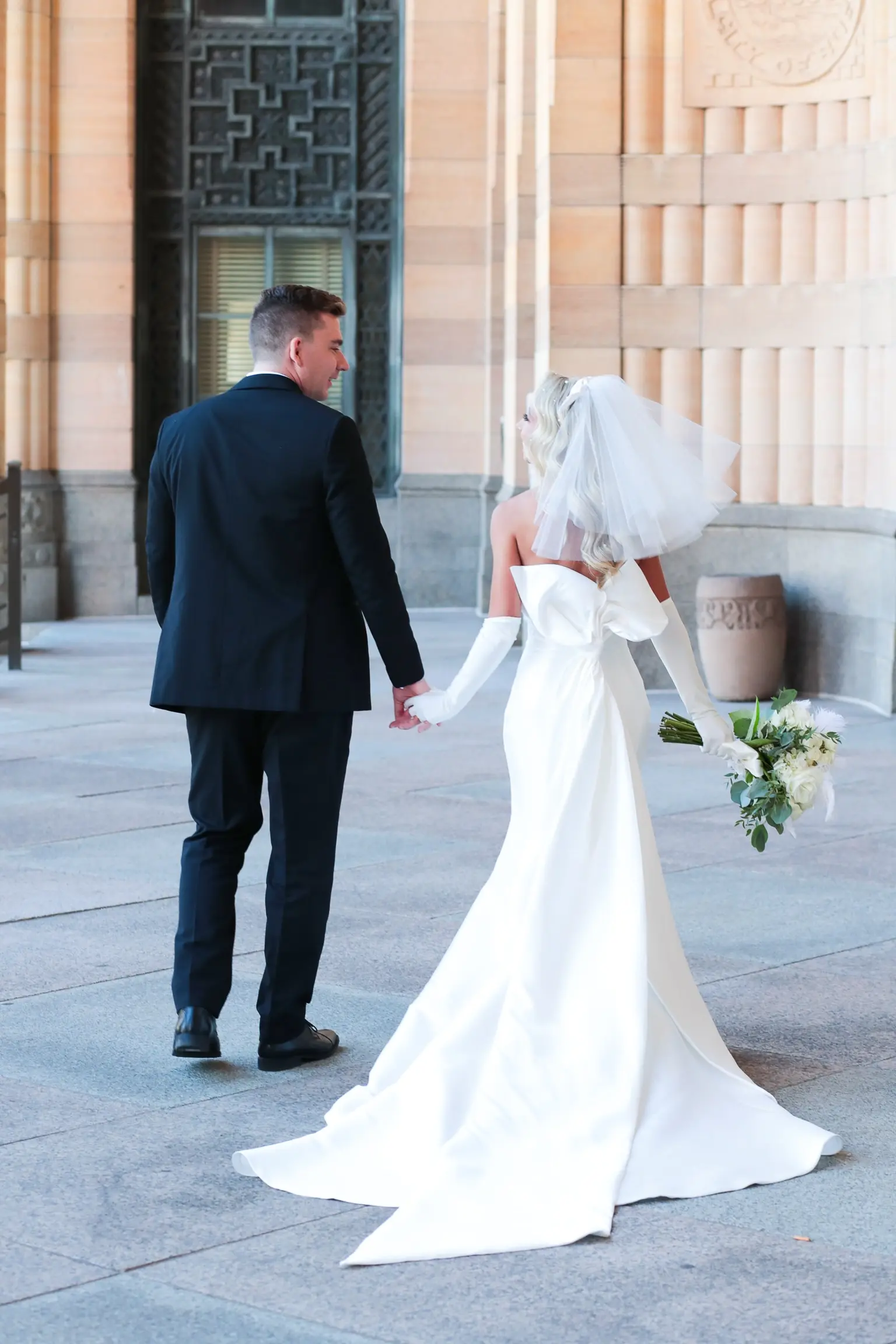 Bride In 90's Inspired Wedding Dress Called Mitchell By Maggie Sottero with Groom, Bridal Gloves, And Wedding Veil