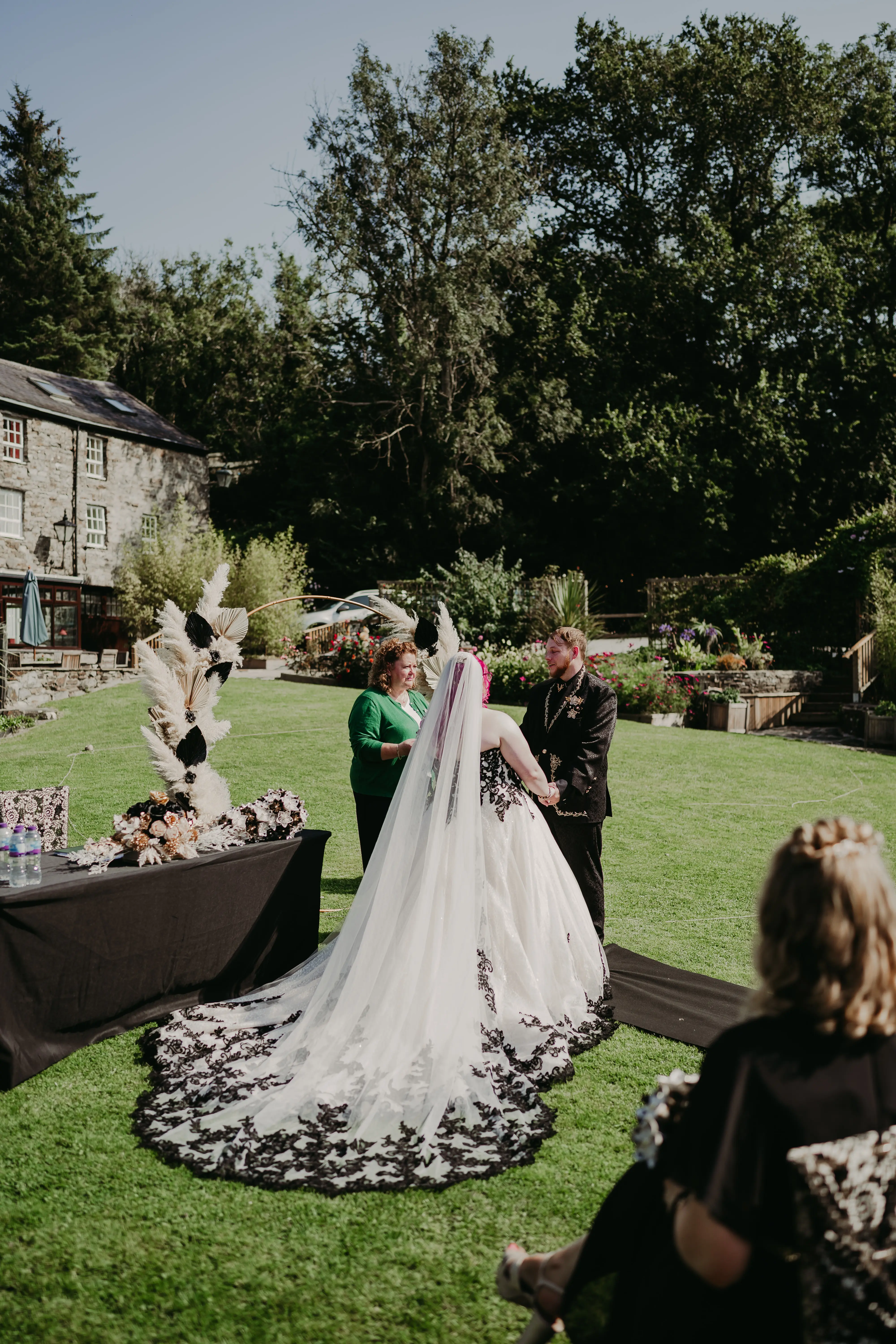 Bride Wearing Gothic Black Lace Wedding Dress Called Tristyn By Maggie Sottero With Groom At The Ceremony