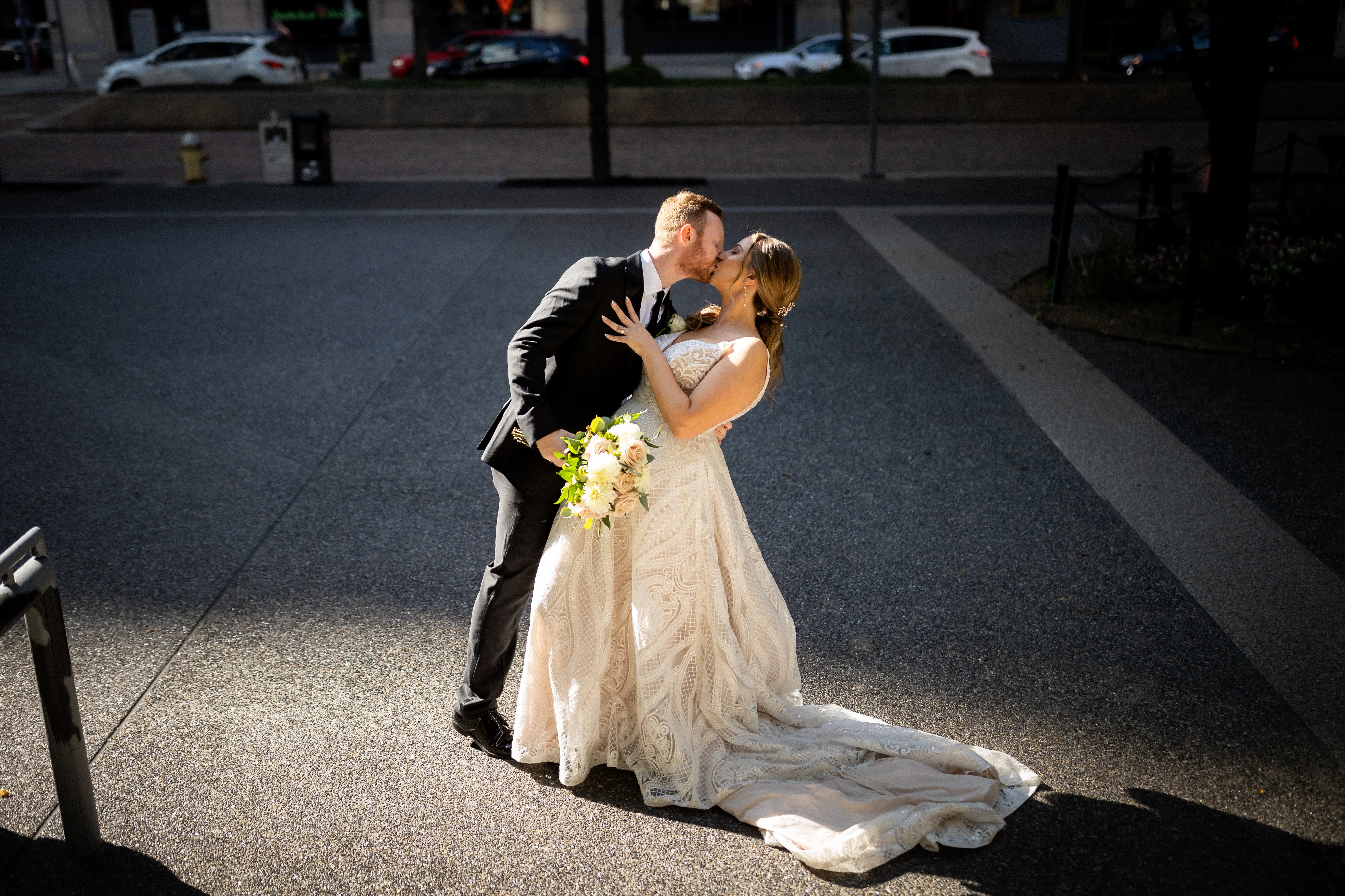 Bride Wearing Glam Princess A-Line Wedding Dress Called Roxanne By Sottero And Midgley Kissing Groom