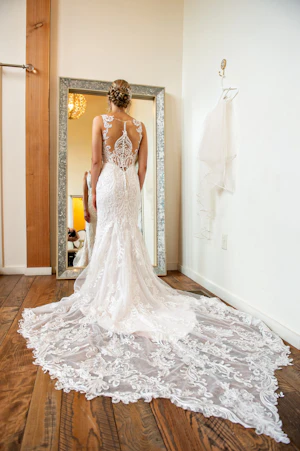 Bride in Elegant Lace Sheath Wedding Dress with Beaded Lace Motifs over Textured Tulle Called Hamilton by Sottero & Midgley