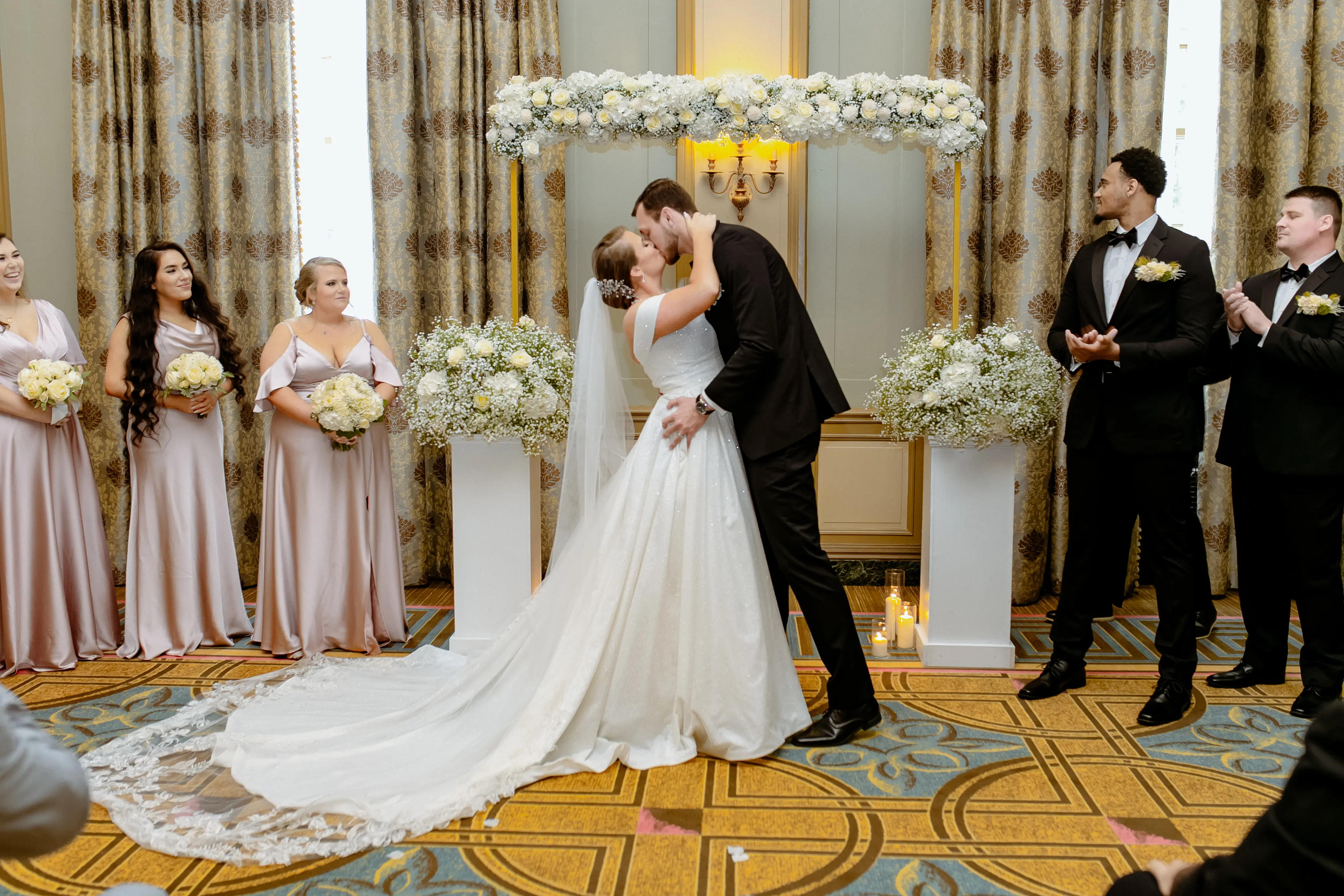 Bride wearing Anniston by Maggie Sottero kissing her husband during their ceremony