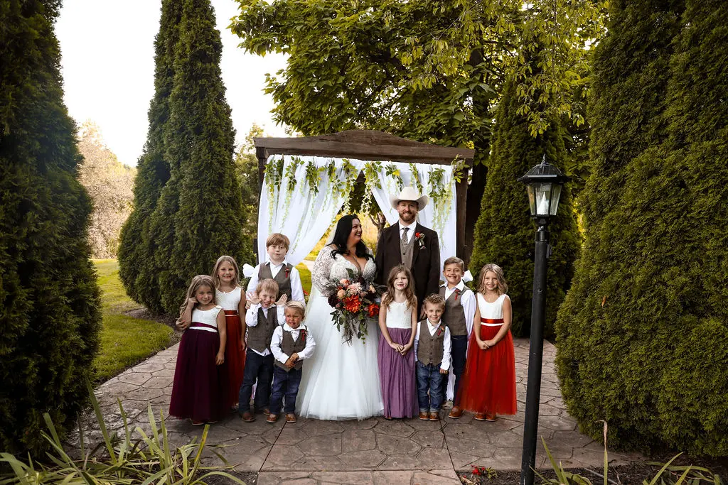 Bride wearing Princess Ballgown Wedding Dress called Mallory Dawn by Maggie Sottero with her groom and children