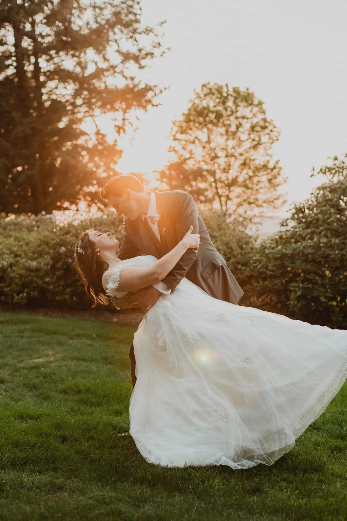 Bride wearing Mason by Sottero and Midgley being dipped by her husband