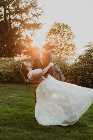 Bride wearing Mason by Sottero and Midgley being dipped by her husband