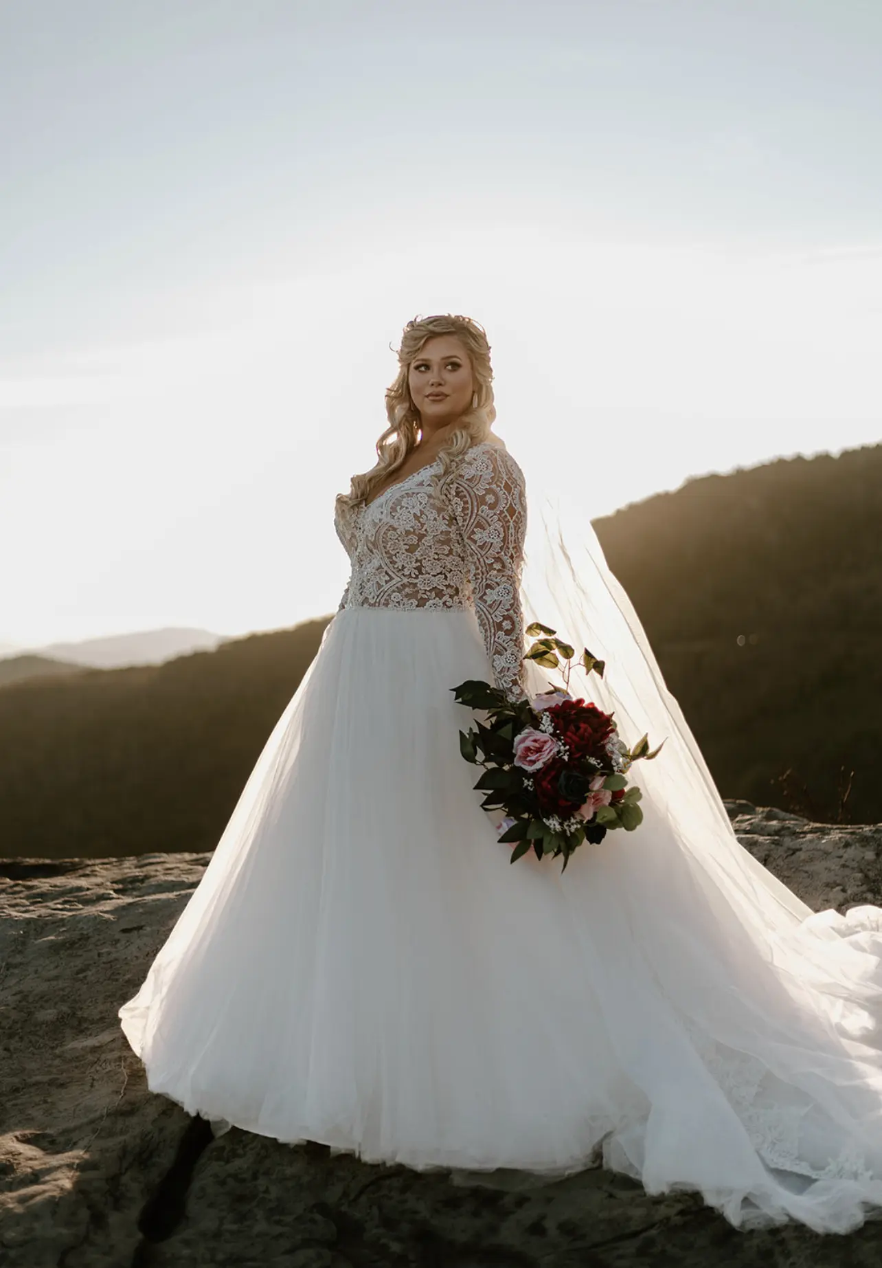 Bride With Flower Bouquet In Long Sleeve Tulle Ball Gown Wedding Dress Named Mallory Dawn By Maggie Sottero