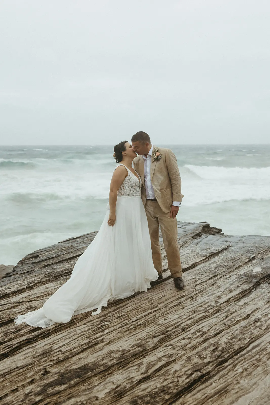 Bride with groom wearing boho wedding dress with keyhole back.