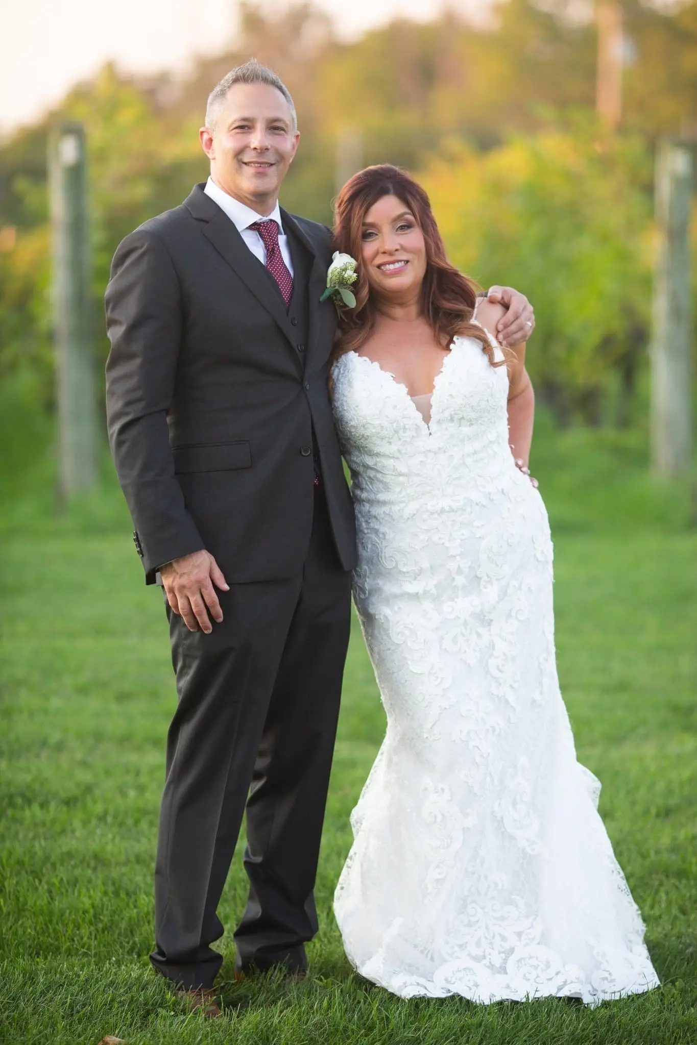 Bride Wearing Sexy Mermaid Wedding Dress Called Tuscany By Maggie Sottero Leaning Against Groom Outside
