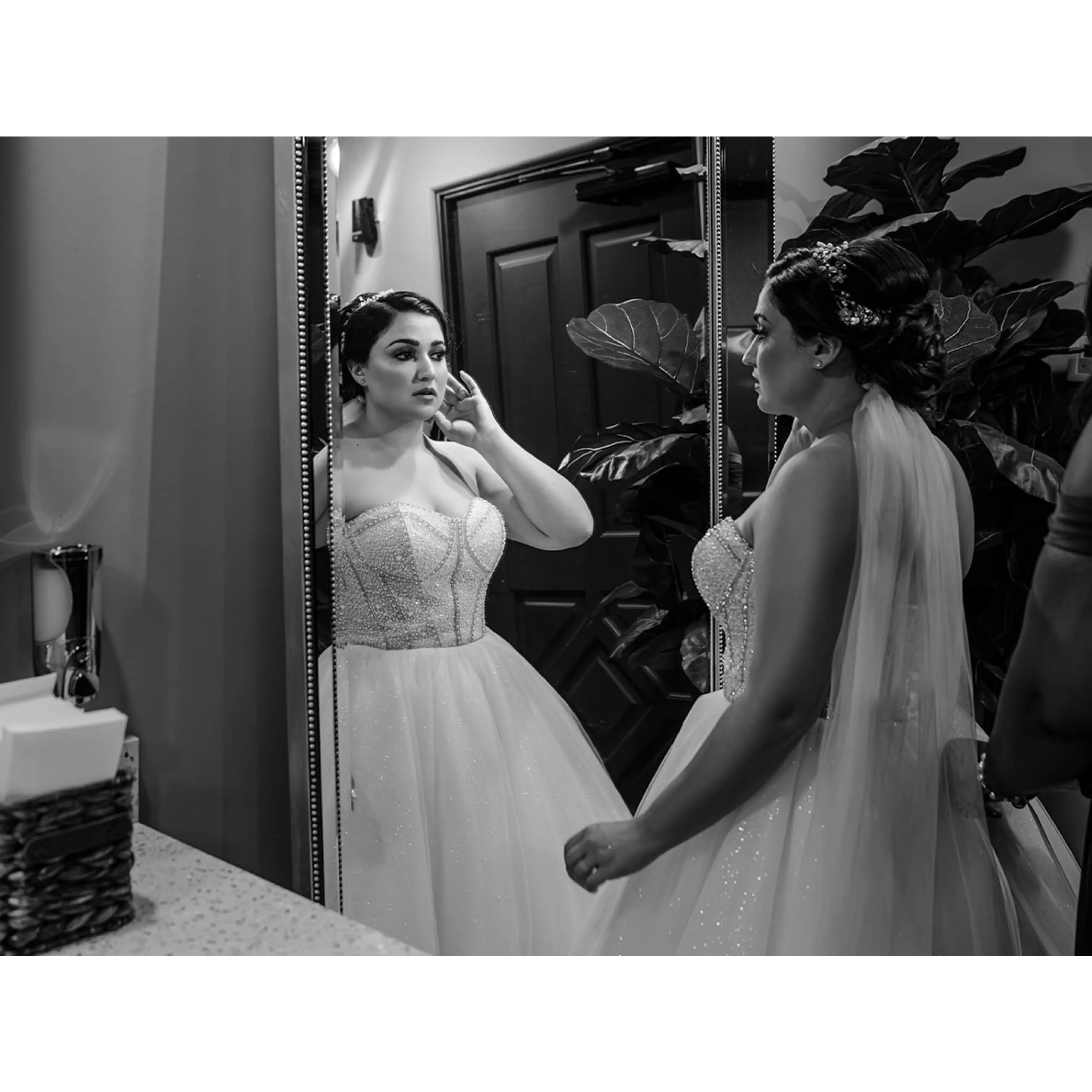 Bride wearing Elton wedding dress by Sottero and Midgley looking in the mirror