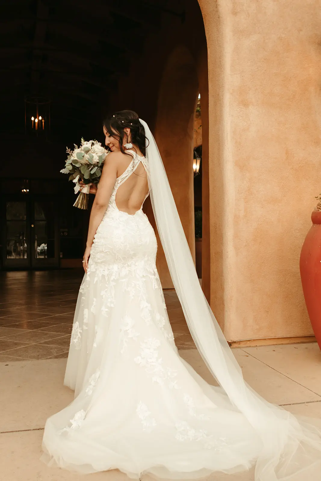 Bride wearing backless wedding dress called Elizabetta.