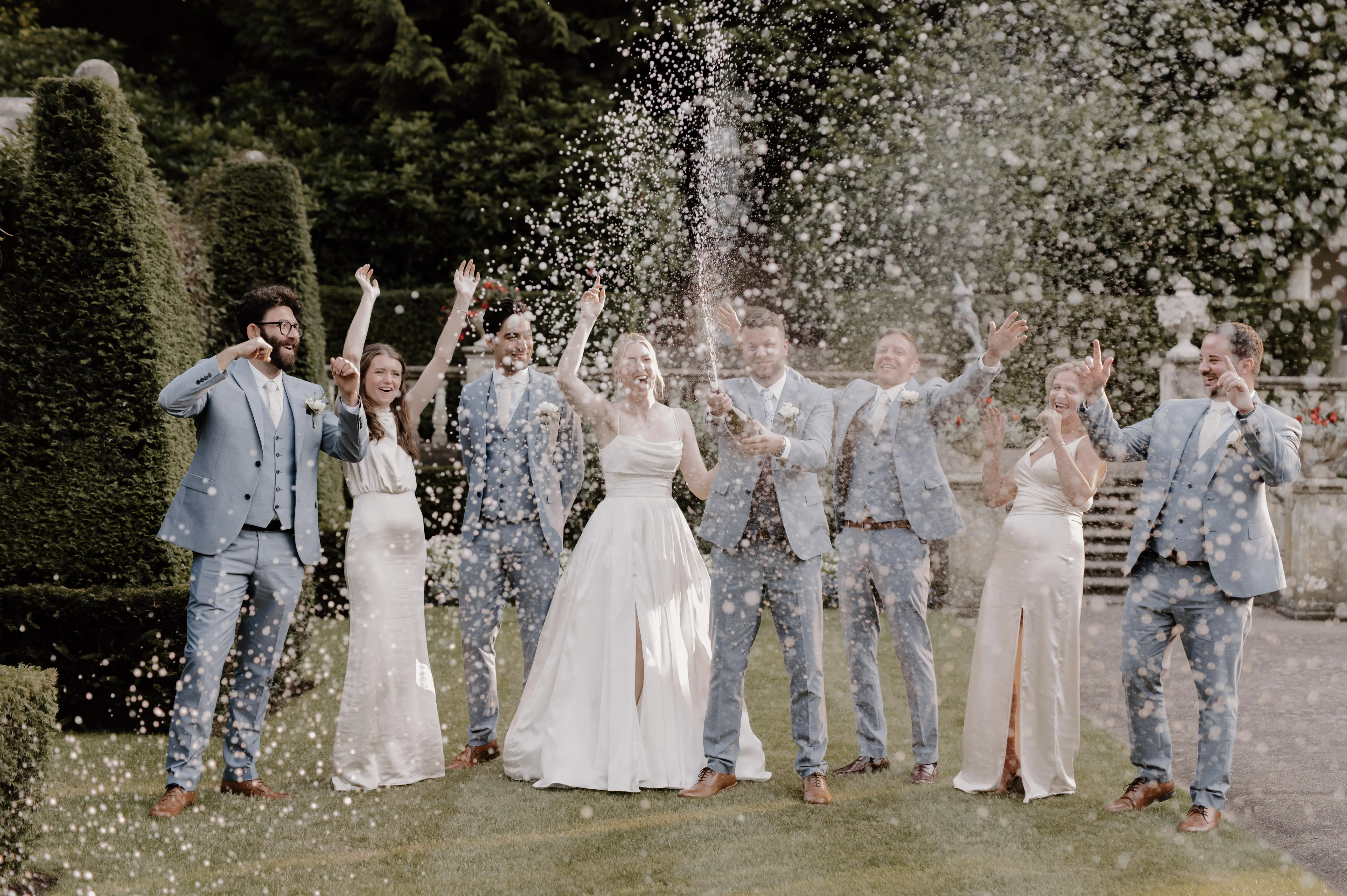 Bride wearing Scarlet by Maggie Sottero and her wedding party celebrating