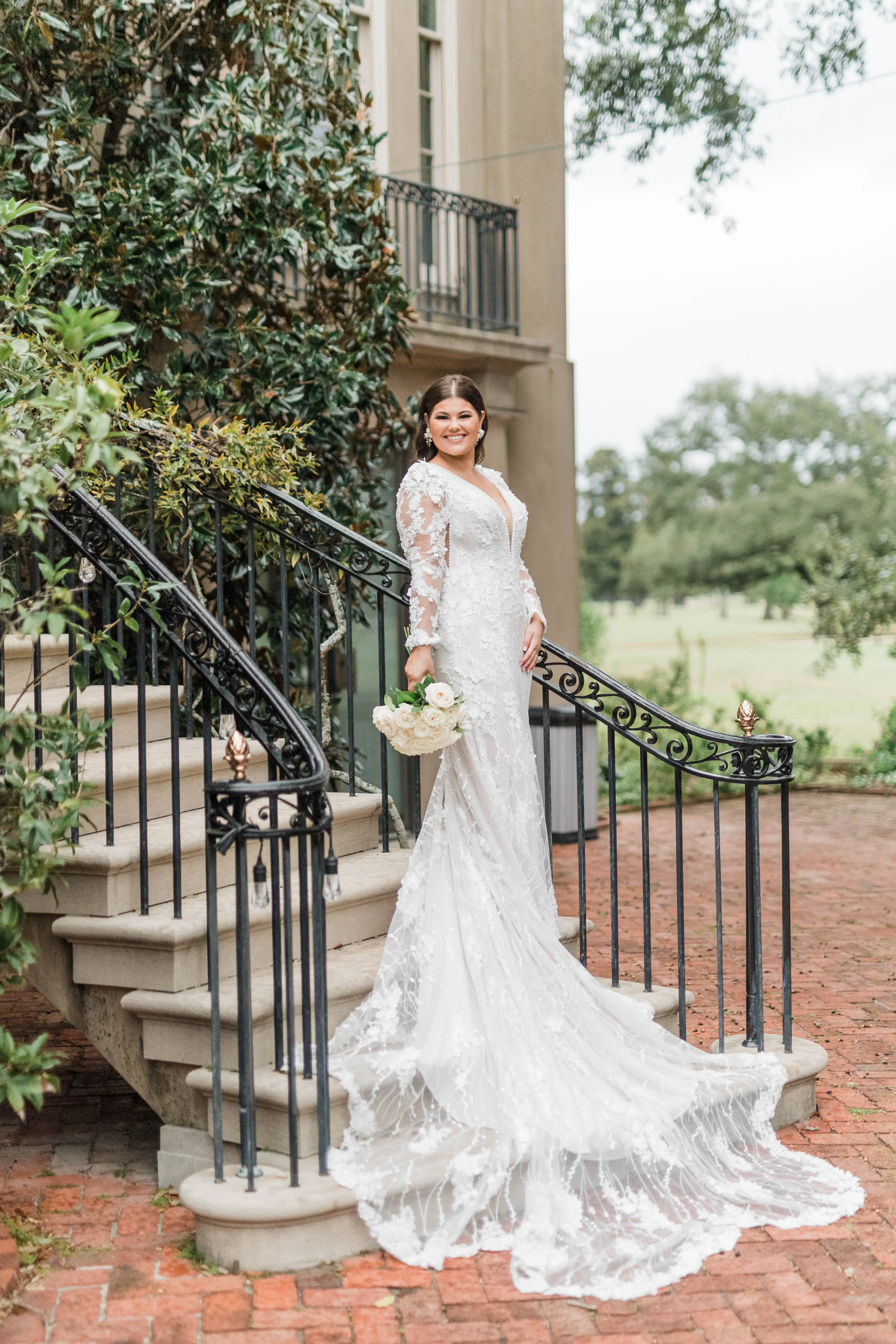 Bride In Long Sleeve Sheath Wedding Dress Called Cruz By Sottero And Midgley With Simple Bouquet