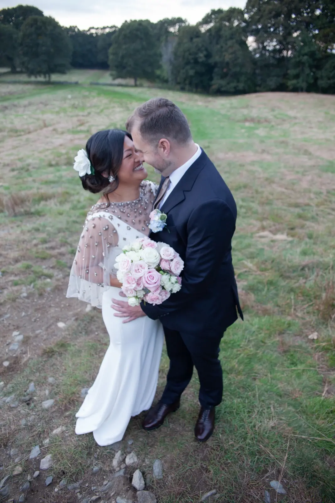 Groom and Bride Wearing Minimalist Crepe Fit-and-Flare Wedding Dress Called Fernanda by Maggie Sottero