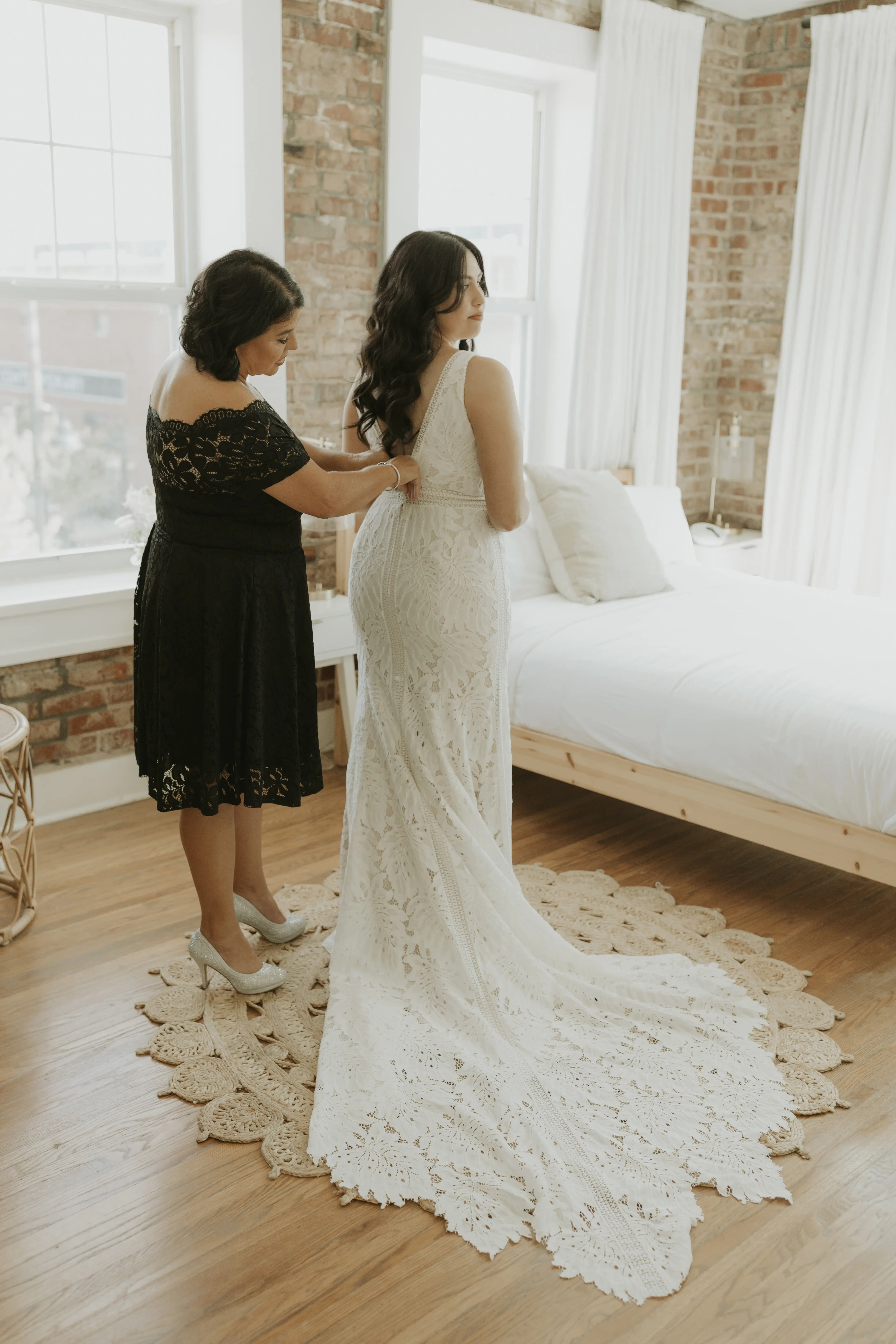Mother of bride fastening her wedding dress called Burke.