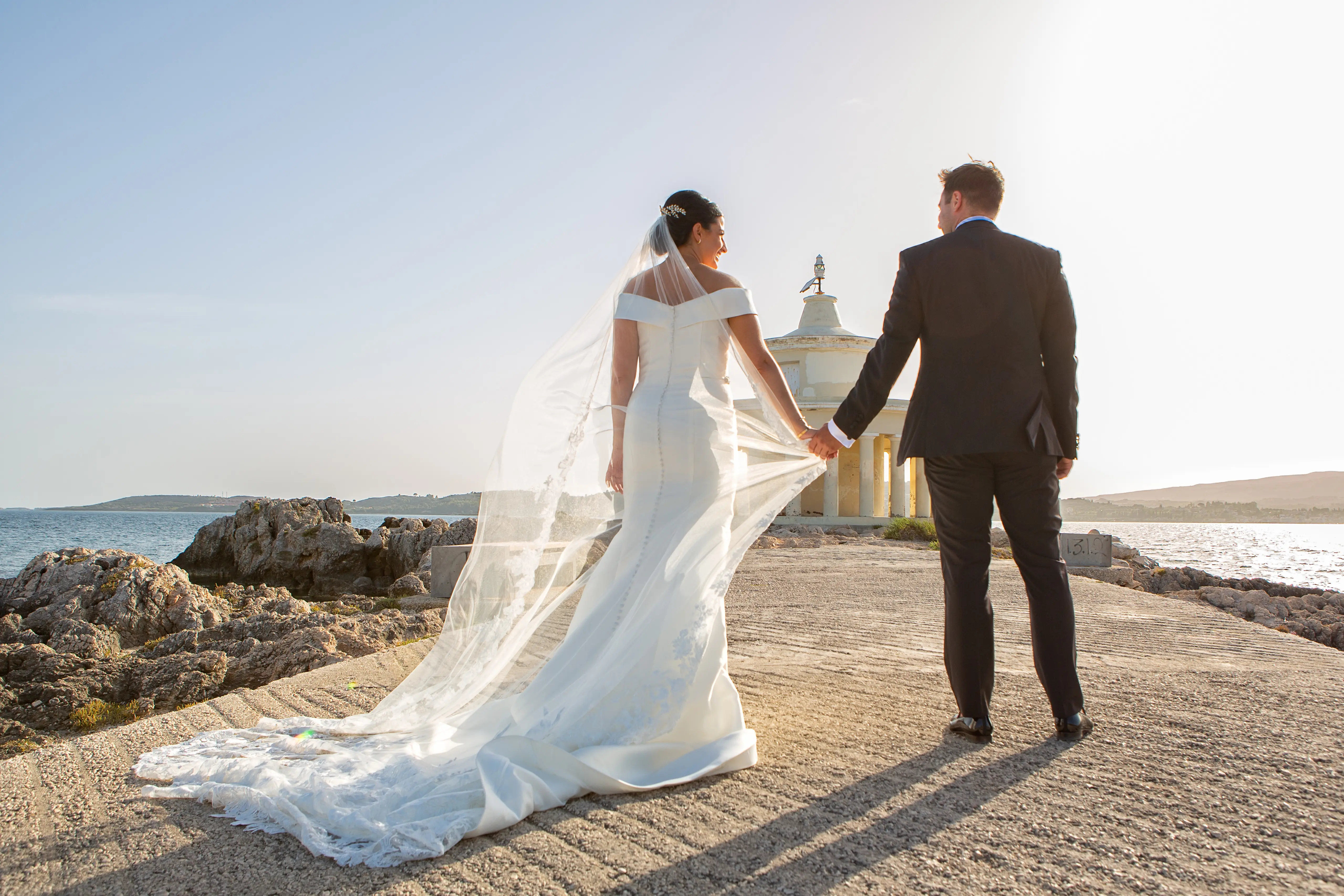 Bride wearing Simple Fit-and-Flare Wedding Dress called Josie by Rebecca Ingram holding hands with the groom