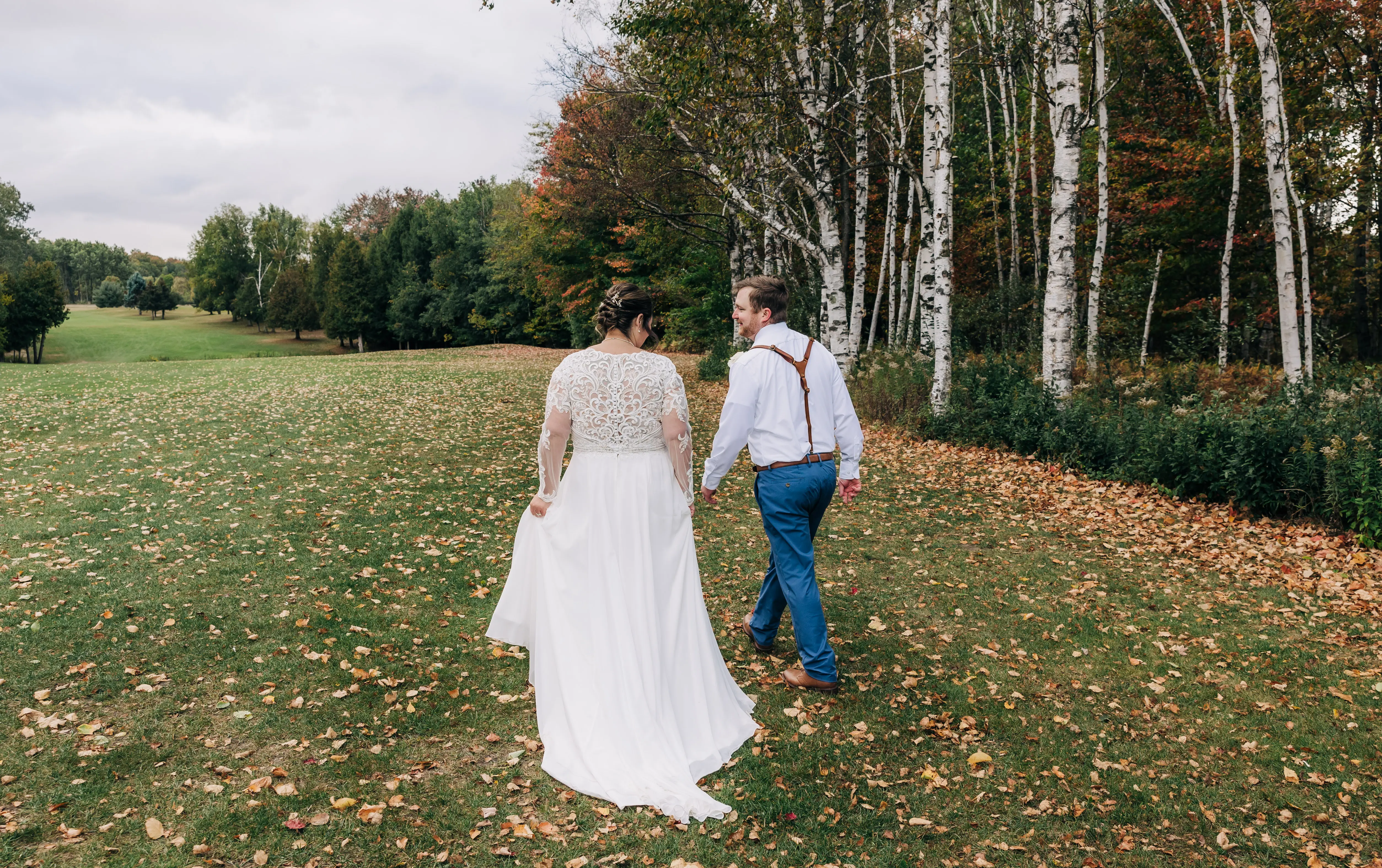Bride Wearing Boho Wedding Dress Called Lorraine Dawn By Rebecca Ingram Walking With Grooom