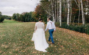 Bride Wearing Boho Wedding Dress Called Lorraine Dawn By Rebecca Ingram Walking With Grooom