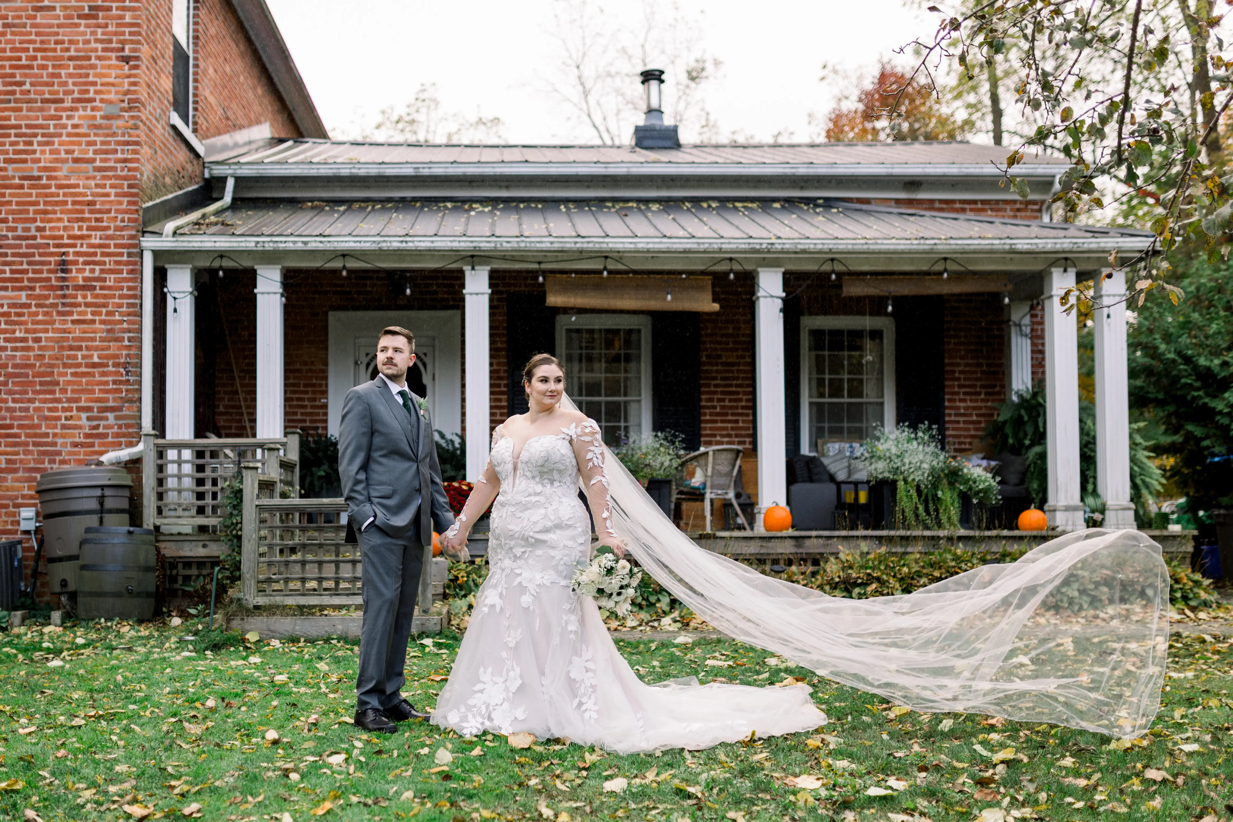 Bride wearing Hattie by Rebecca Ingram holding hands with her husband