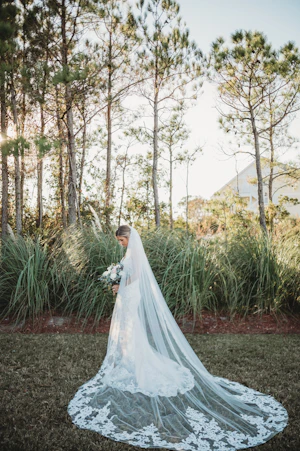 Bride in Mermaid Wedding Dress with Shimmering Lace Motifs and Illusion Plunging Sweetheart Neckline Called Tuscany by Maggie Sottero with Veil