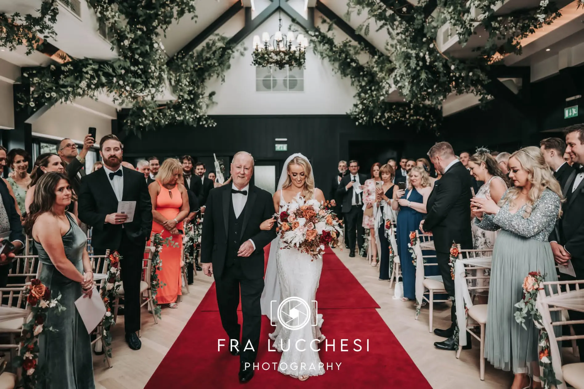 Bride wearing Bailey wedding dress by Sottero and Midgley walking down the aisle