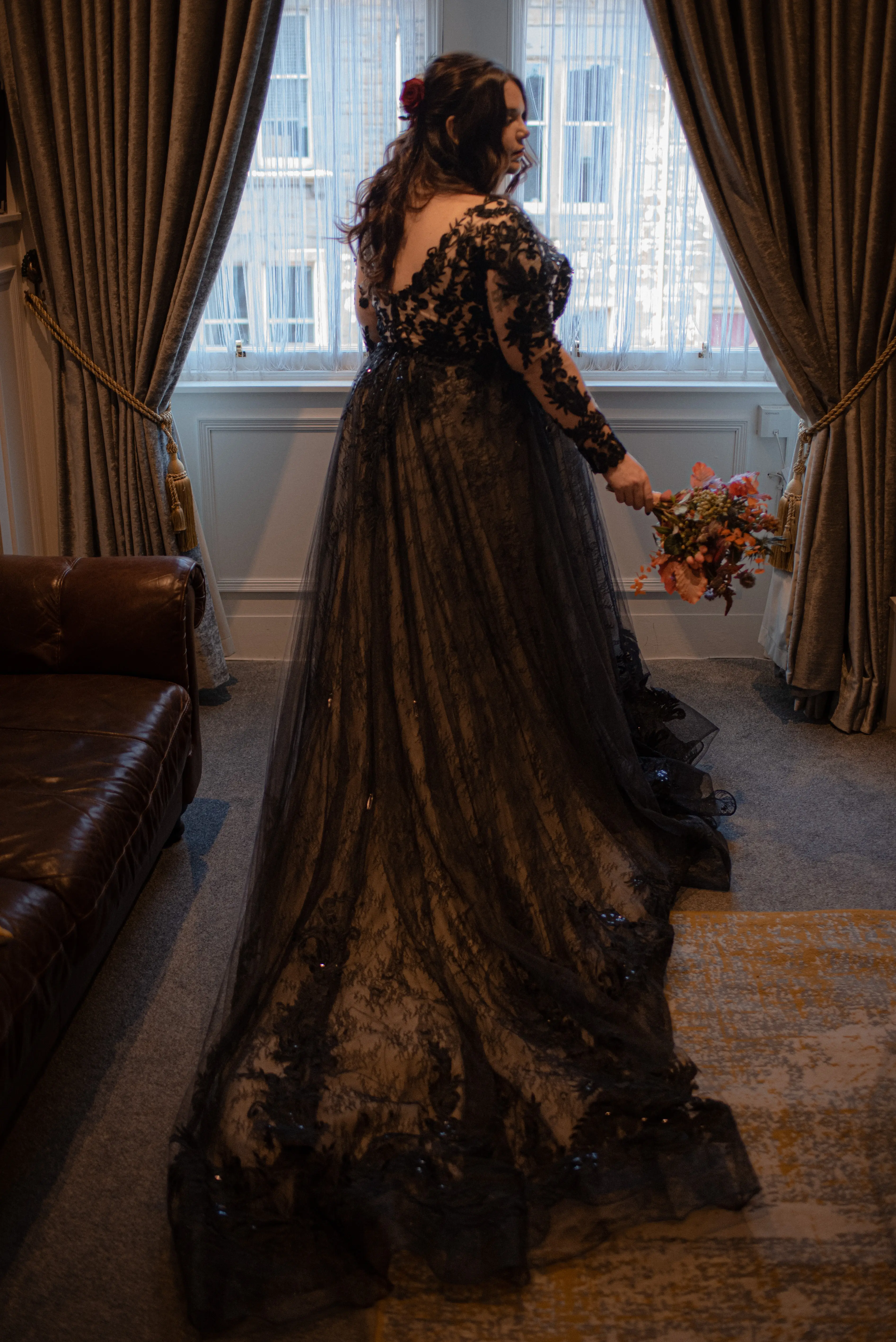 Bride Wearing Black A-Line Wedding Dress Called Zander By Sottero And Midgley Holding Bouquet
