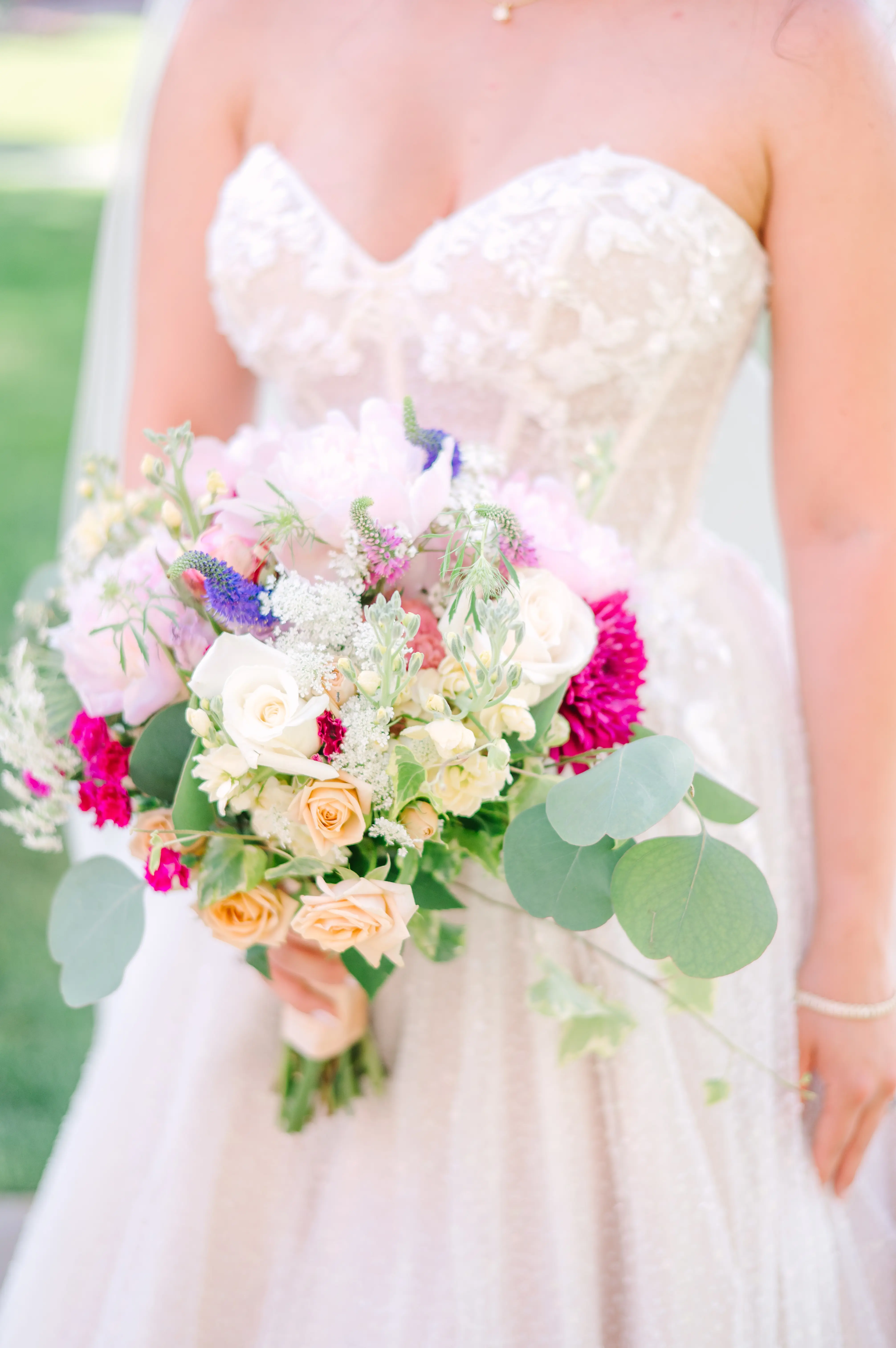 Bride In White Wedding Dress Named Shasta By Sottero and Midgley With Veil And Pink Flowers