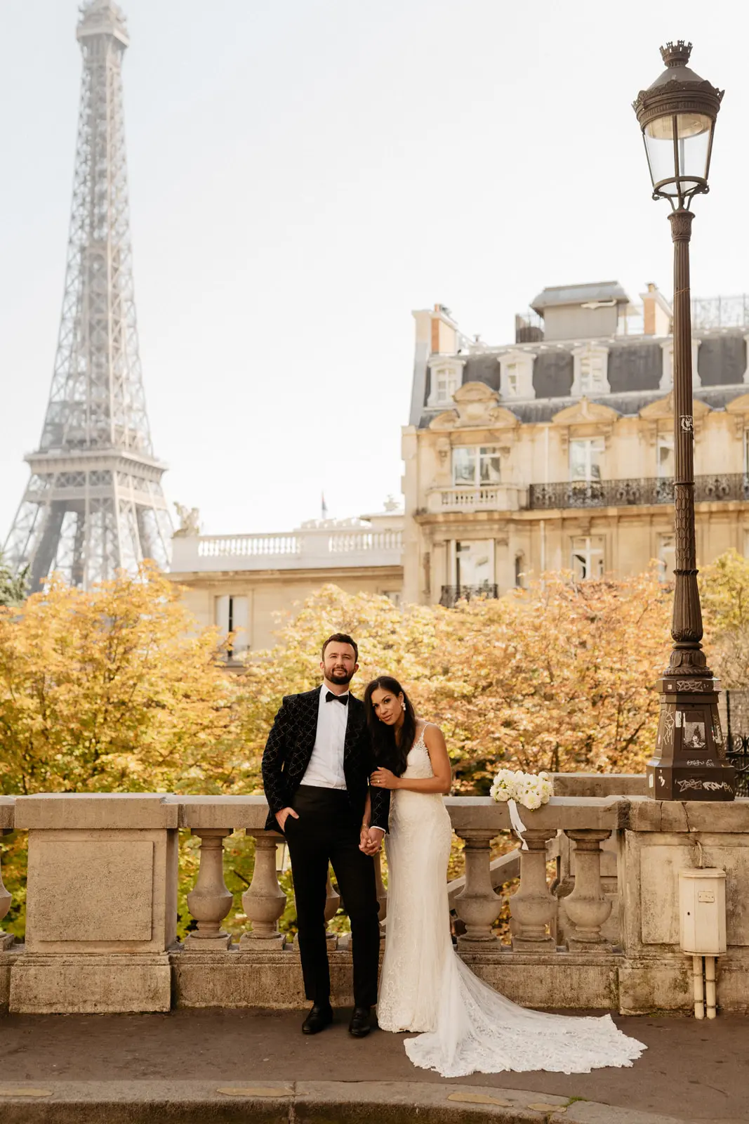Groom Posing With Bride Wearing a Beaded Lace Sheath Bridal Gown Called Barrett By Sottero And Midgley