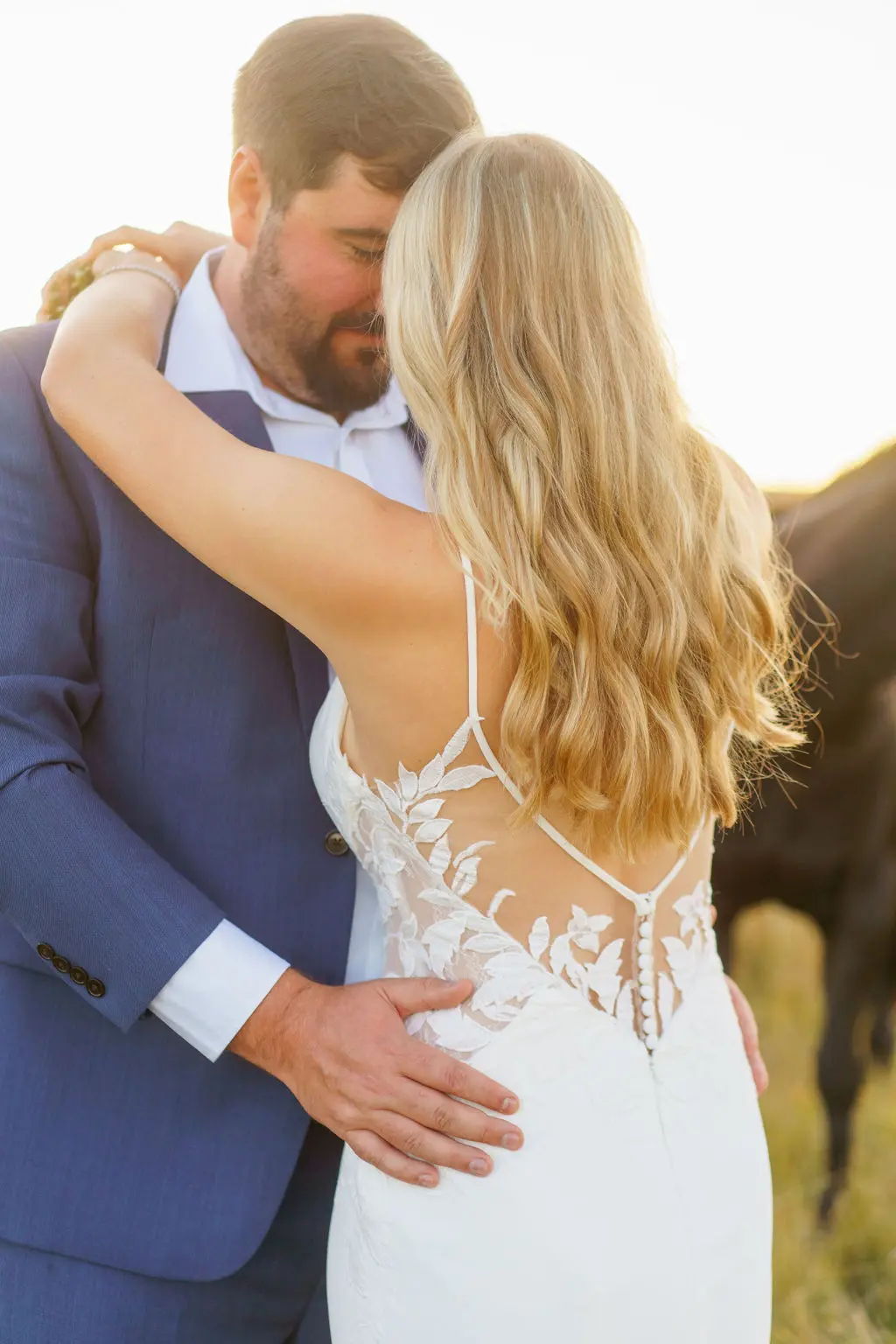 Bride wearing Dionne wedding dress by Rebecca Ingram hugging her husband