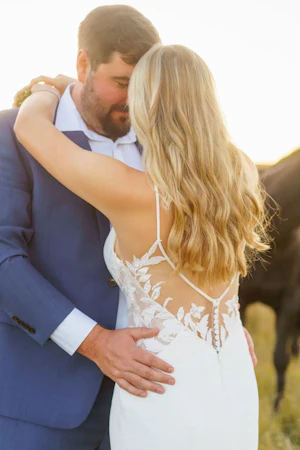 Bride wearing Dionne wedding dress by Rebecca Ingram hugging her husband
