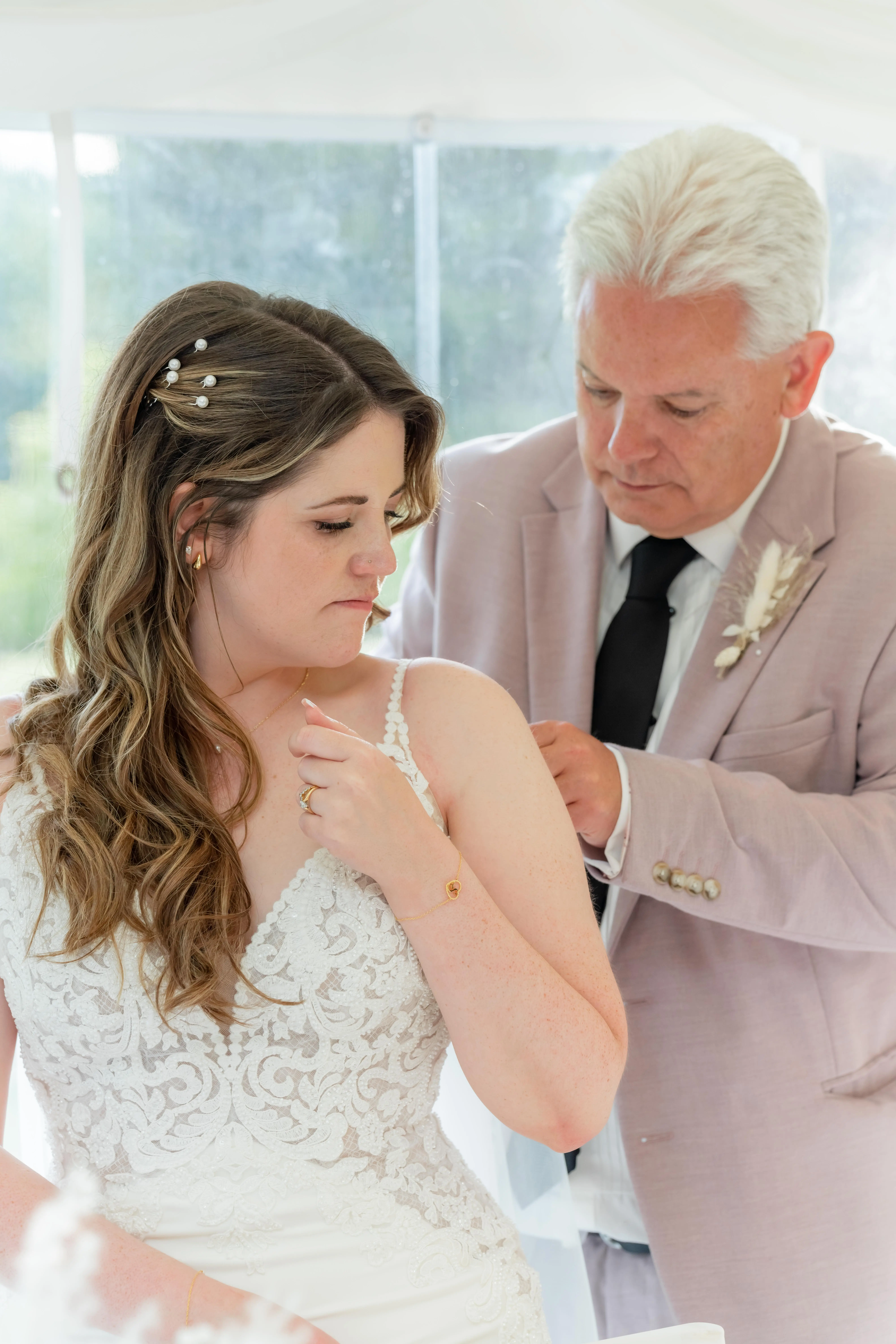 Bride wearing Nikki by Maggie Sottero being zipped up