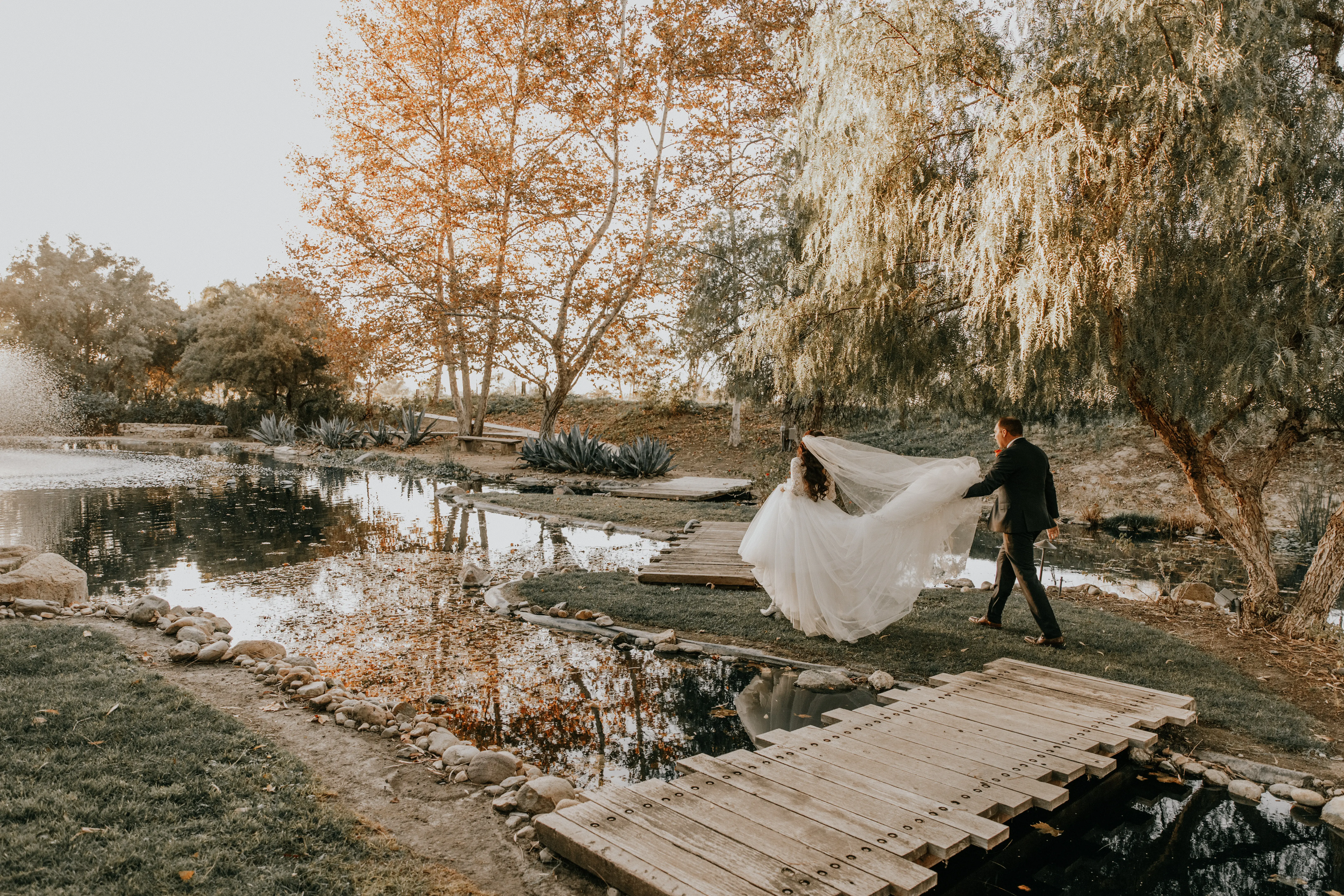 Groom And Bride Walking Together. Bride Wearing Lace Ball Gown Called Mallory Dawn By Maggie Sottero