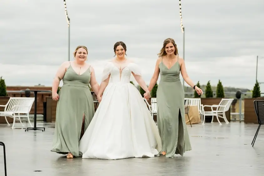 Bride wearing Derrick by Maggie Sottero walkign with her bridesmaids