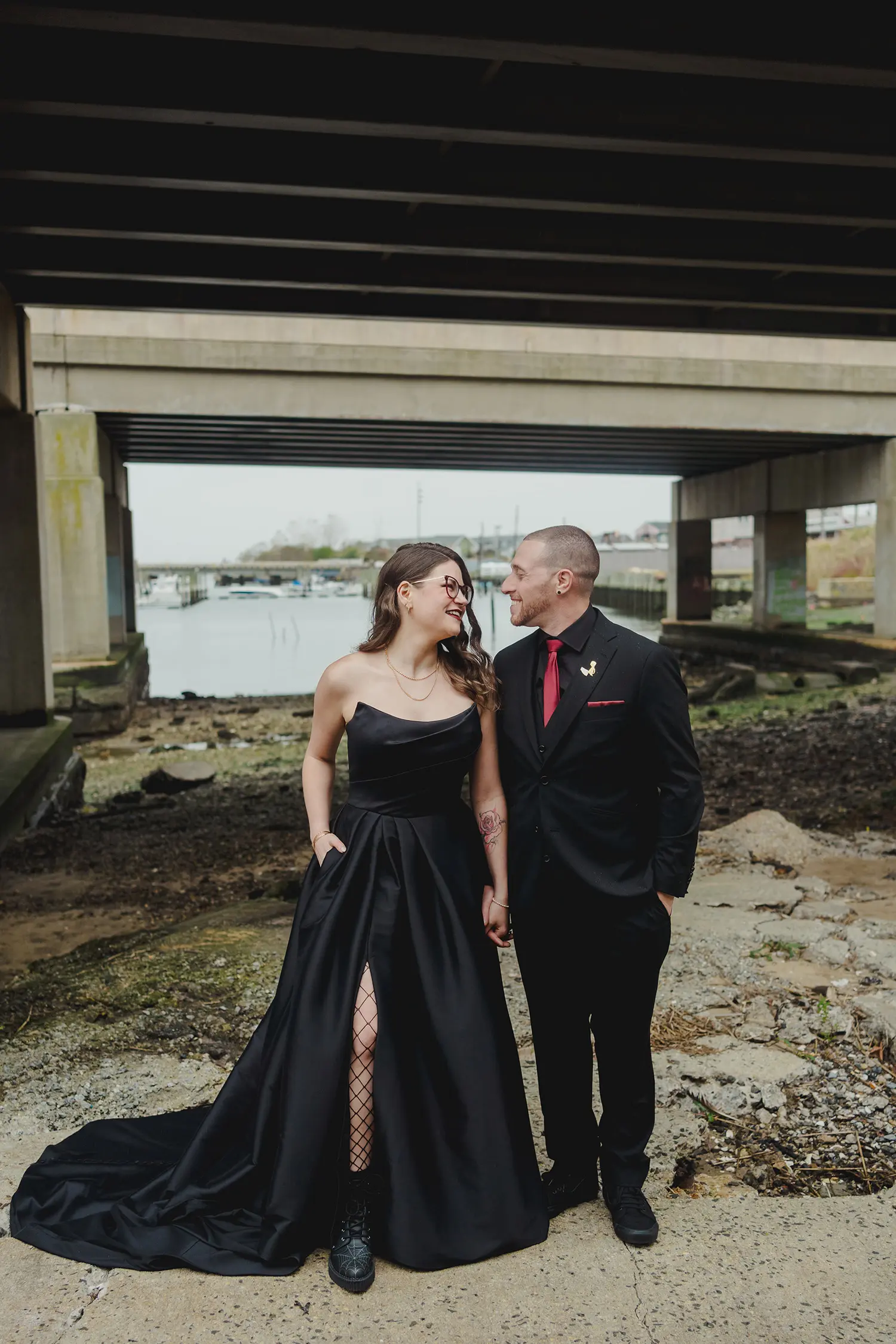 Bride wearing Aspen wedding dress by Sottero and Midgley holding hands with her husband