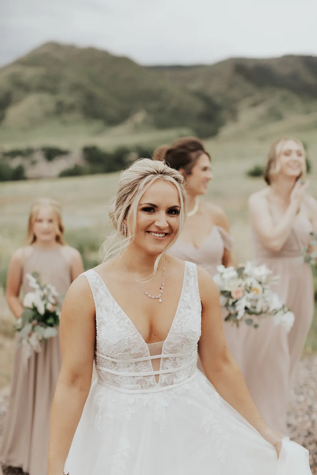 Bride In Lace Backless Wedding Dress Called Raelynn By Rebecca Ingram With Bridesmaids In Blush