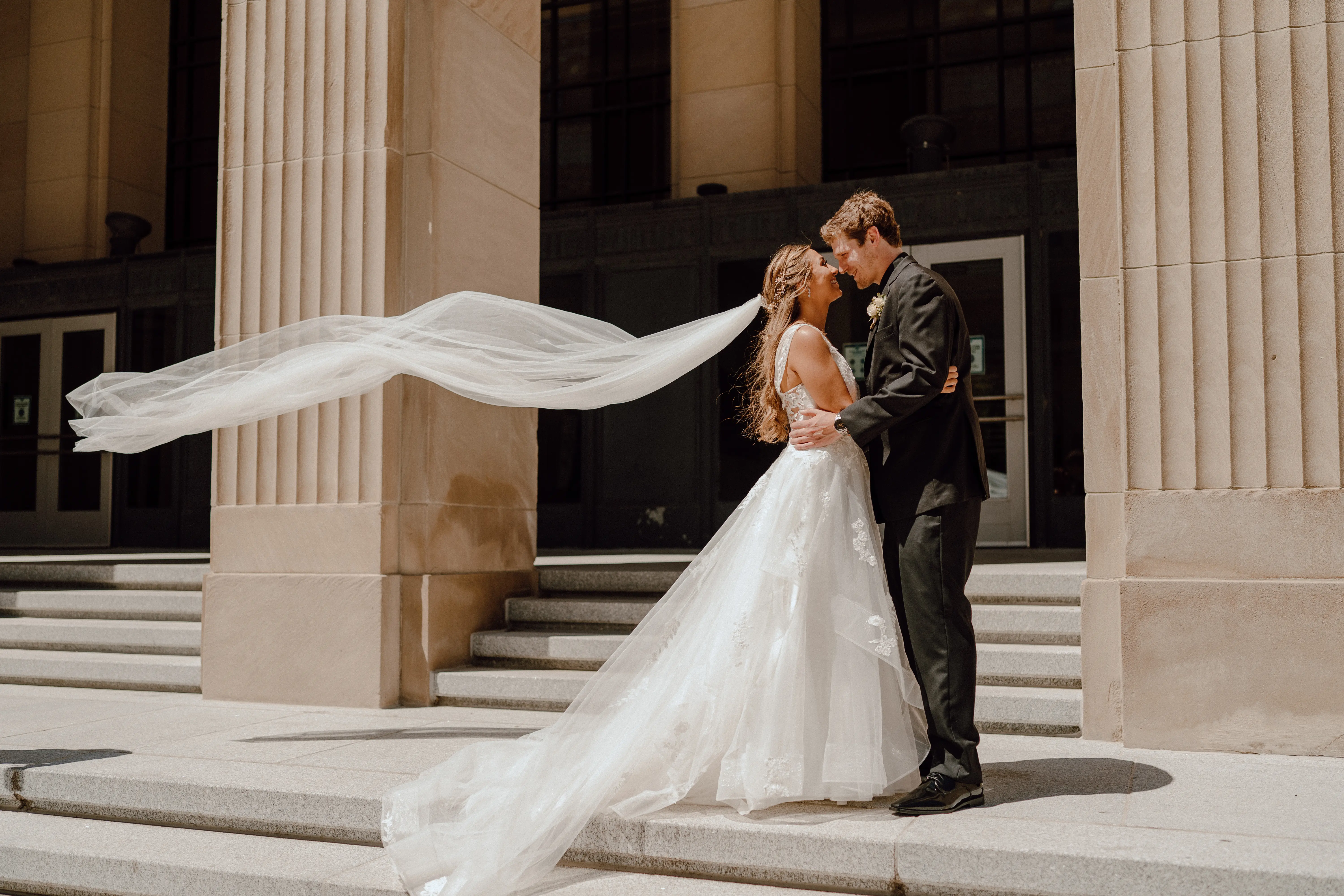 Bride Wearing Floral Ethereal Tulle Wedding Dress Called Lettie By Rebecca Ingram With Long Floating Veil