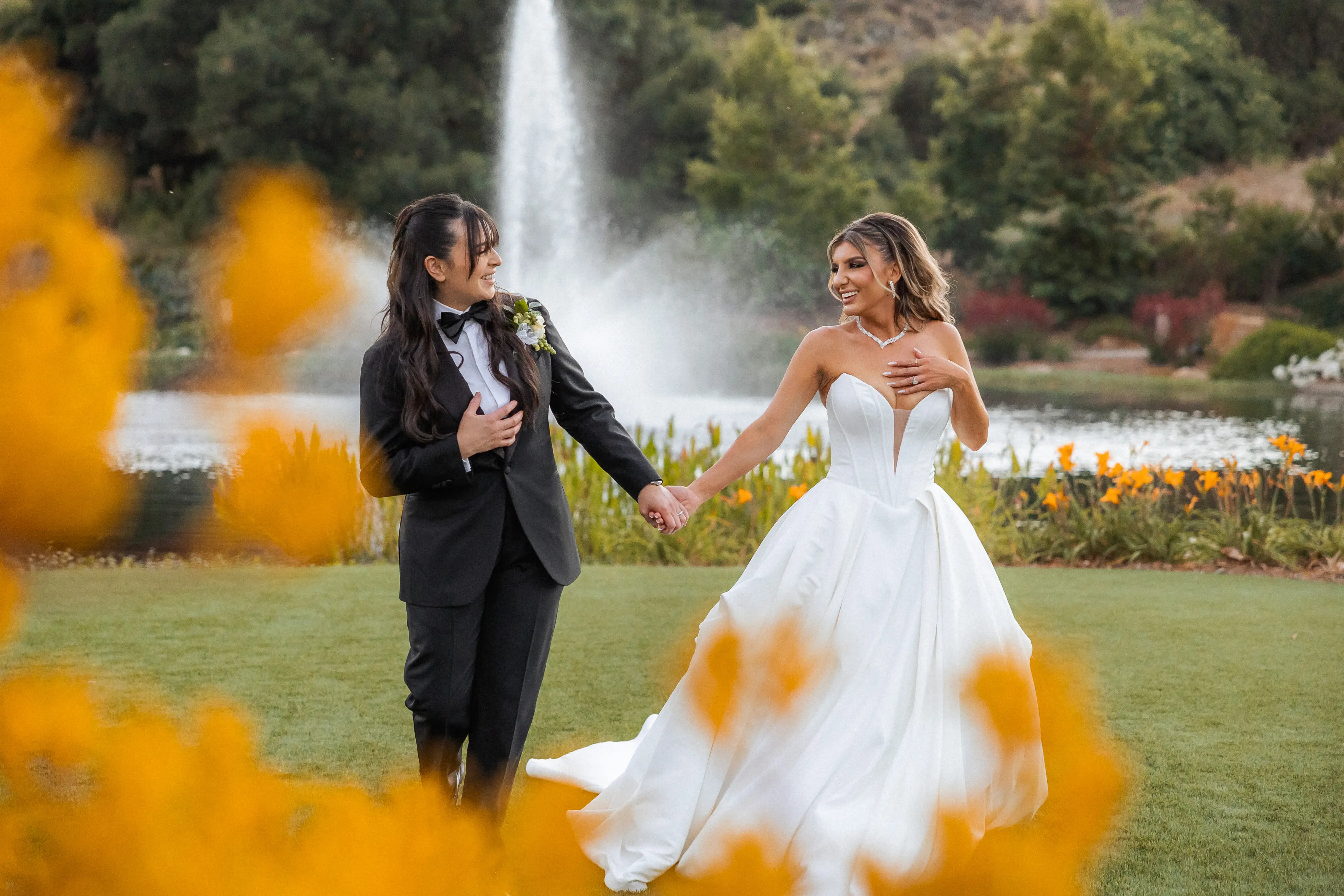Bride wearing Derrick by Maggie Sottero holding hands with her partner