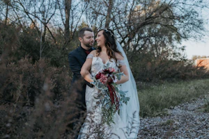 Bride wearing Mermaid Lace wedding dress called Hattie by Rebecca Ingram with her groom