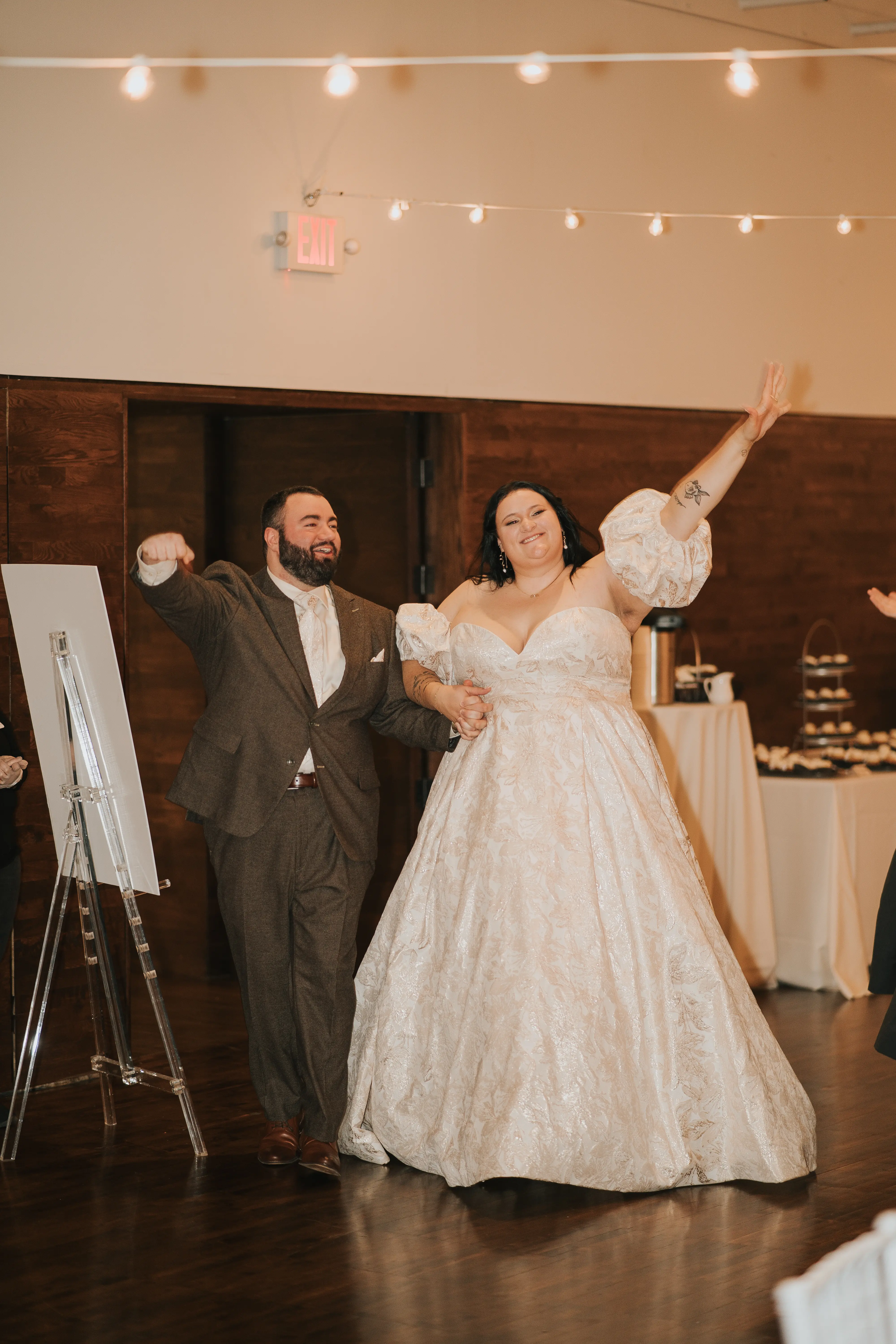 Bride Wearing Floral Jacquard Princess Wedding Gown Called Cyprus By Sottero And Midgley Cheering With Groom At The Reception