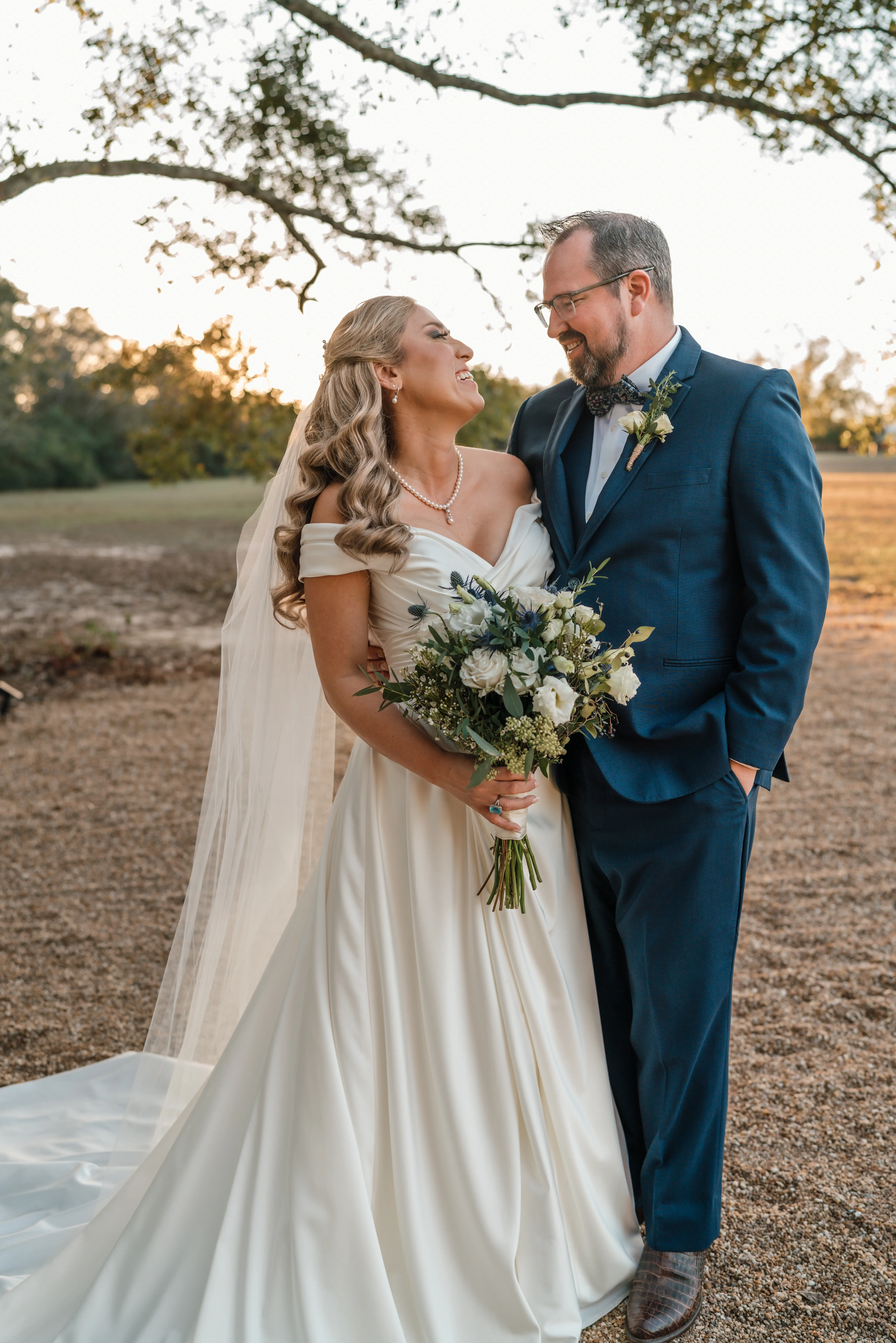 Bride wearing Ekaterina wedding dress by Maggie Sottero laughing with her husband