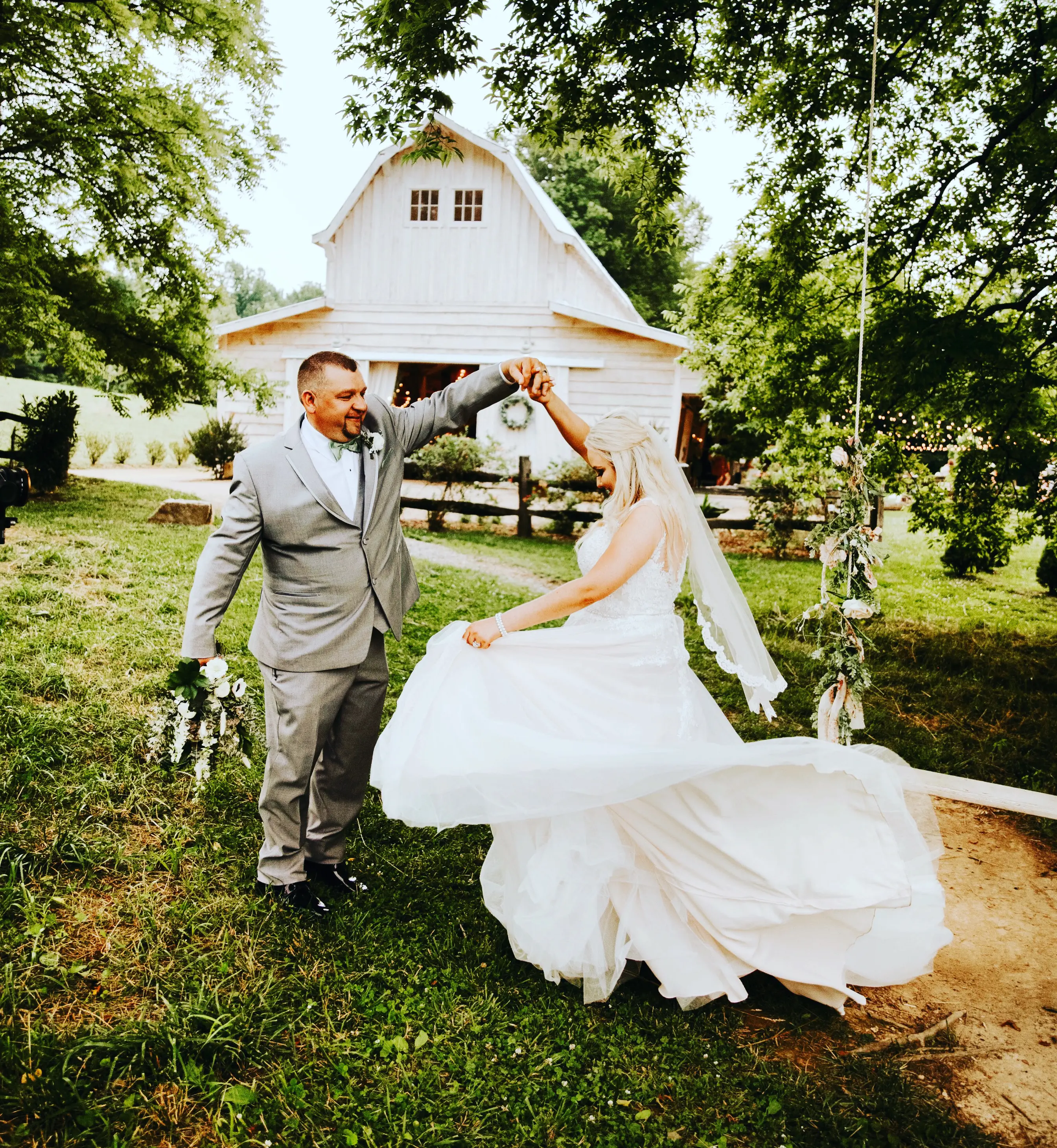 Groom and Bride at an Outdoor Wedding Wearing Lace Ballgown Wedding Dress Called Olivia by Rebecca Ingram