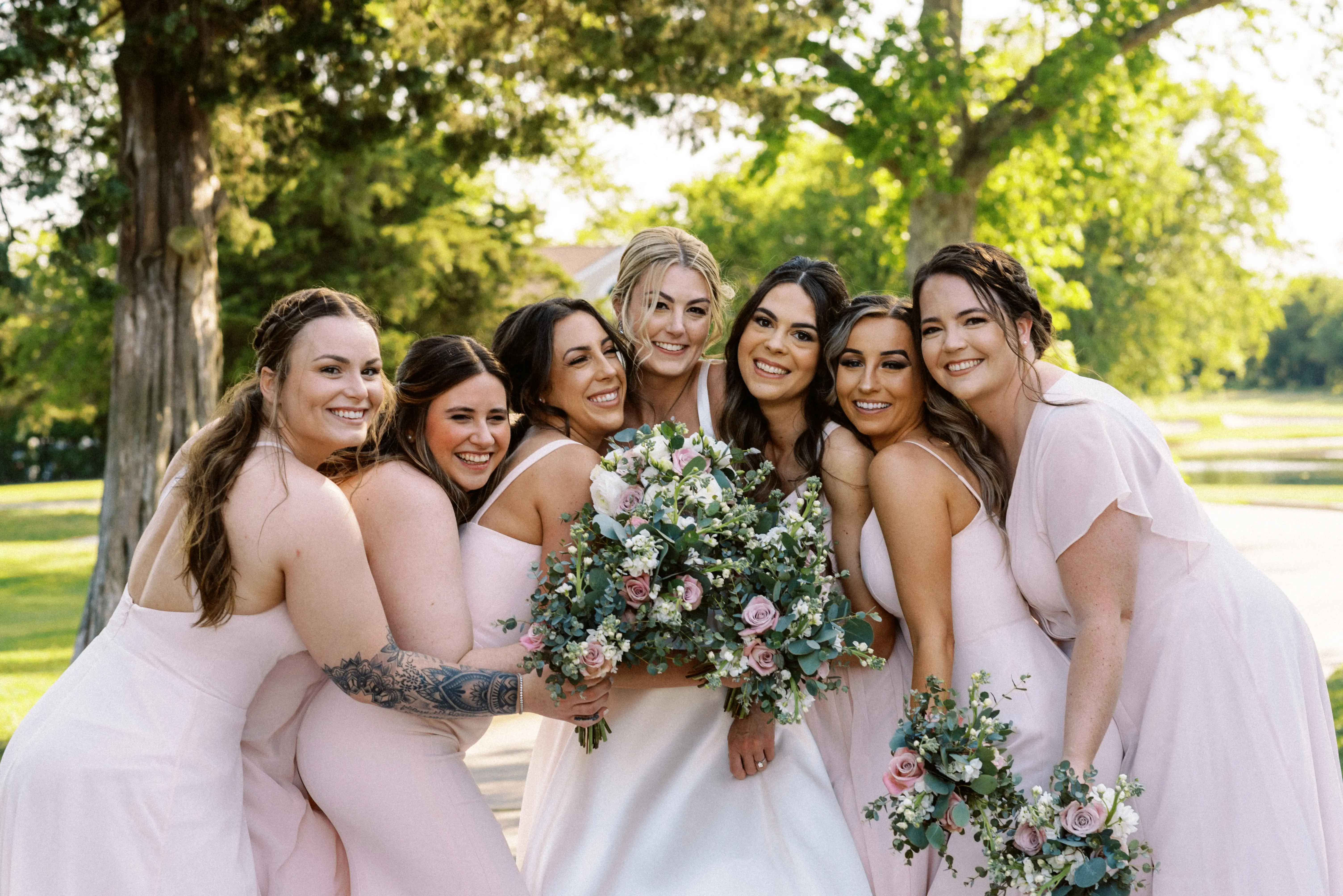 Bride wearing Selena wedding dress by Maggie Sottero with bridesmaids