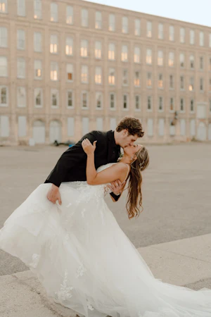 Bride in ruffle dress with illusion bodice called Lettie by Rebecca Ingram with groom