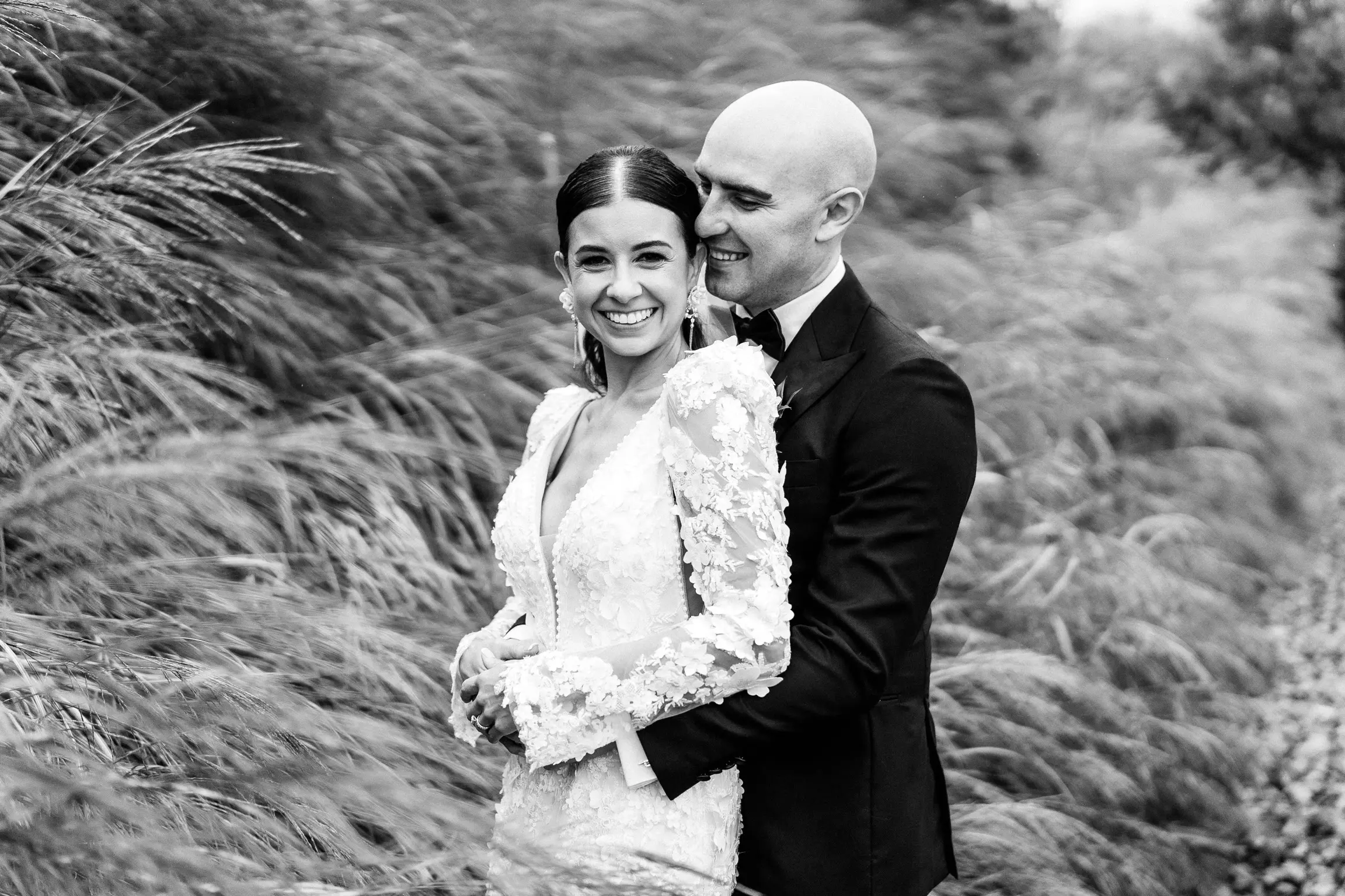 Real Bride wearing puff sleeve wedding dress with 3D floral details called Cruz by Sottero and Midgley..