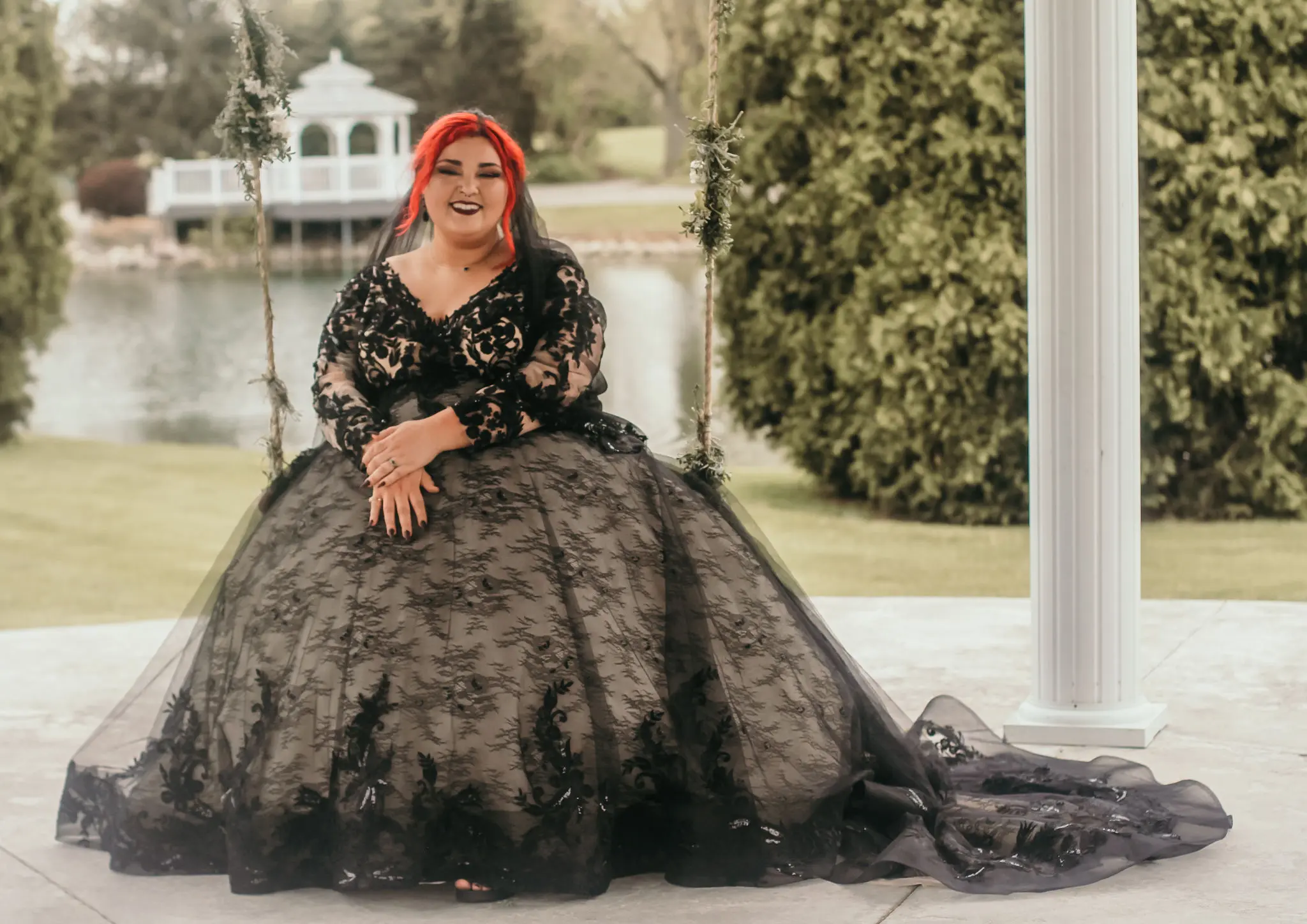 Bride Smiling On Swing In A Black Lacey Ball Gown Wedding Dress Named Zander By Sottero And Midgley