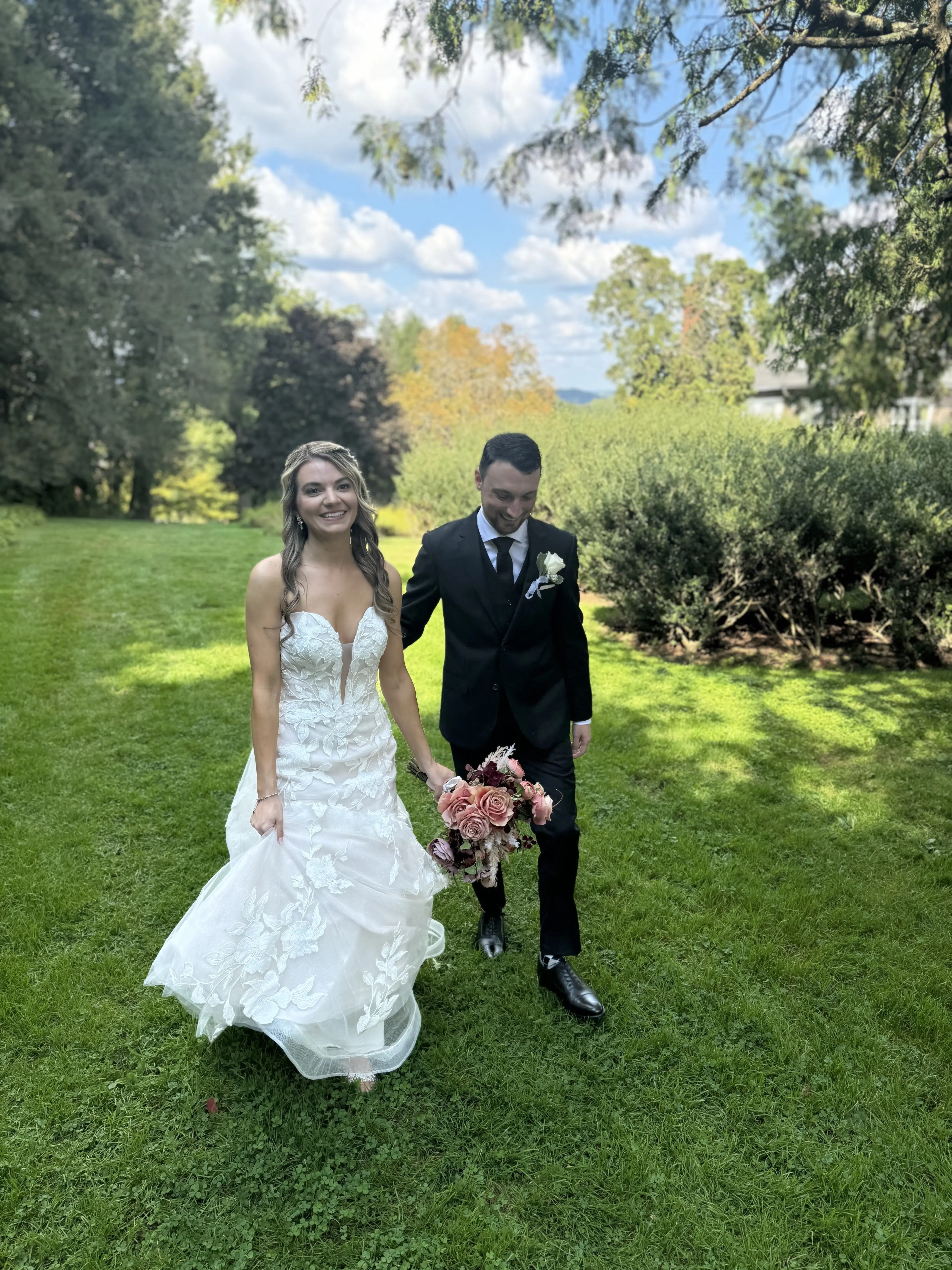 Bride wearing Hattie Marie by Rebecca Ingram walking with her husband
