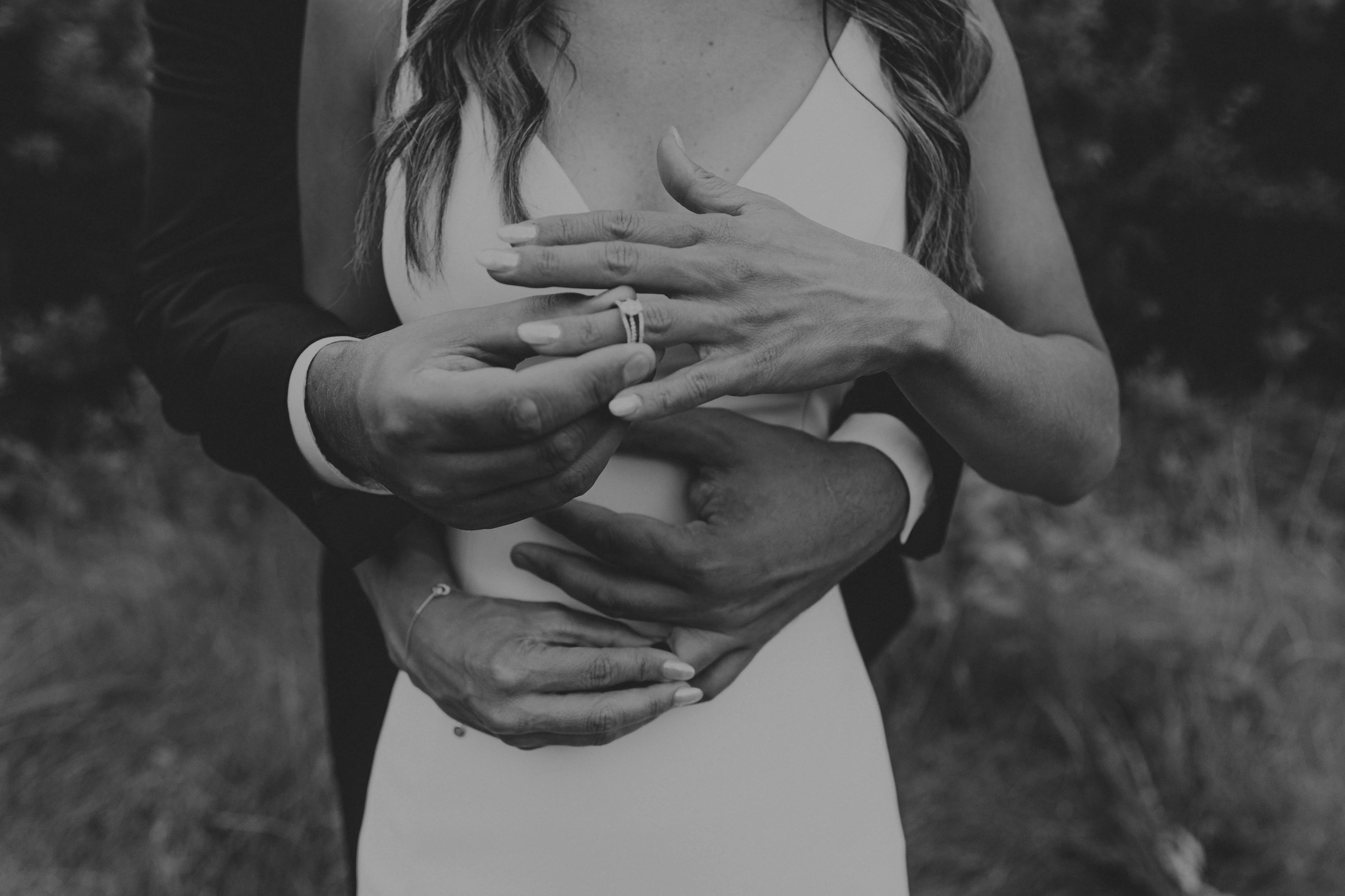 Bride Wearing Simple Fit-and-Flare Wedding Dress Called Fernanda By Maggie Sottero Putting On Her Wedding Ring