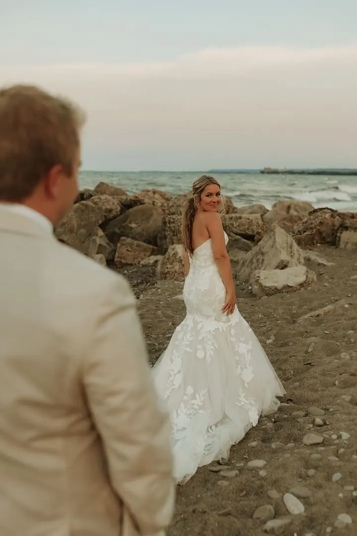 Bride wearing Hattie wedding dress by Rebecca Ingram looking back at her husband